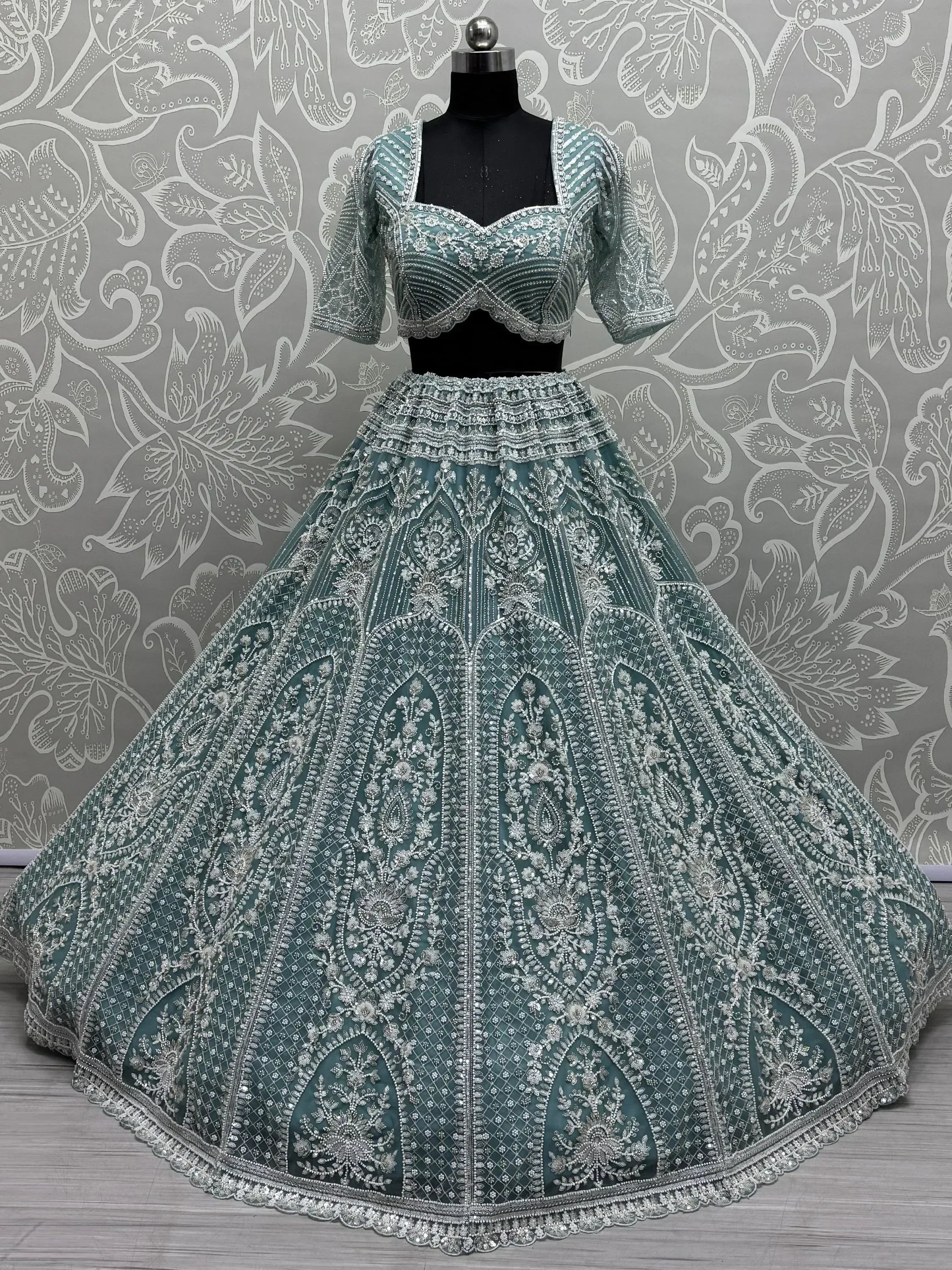 Teal designer lehenga choli with heavy silver embroidery, perfect for Indian weddings and ethnic events