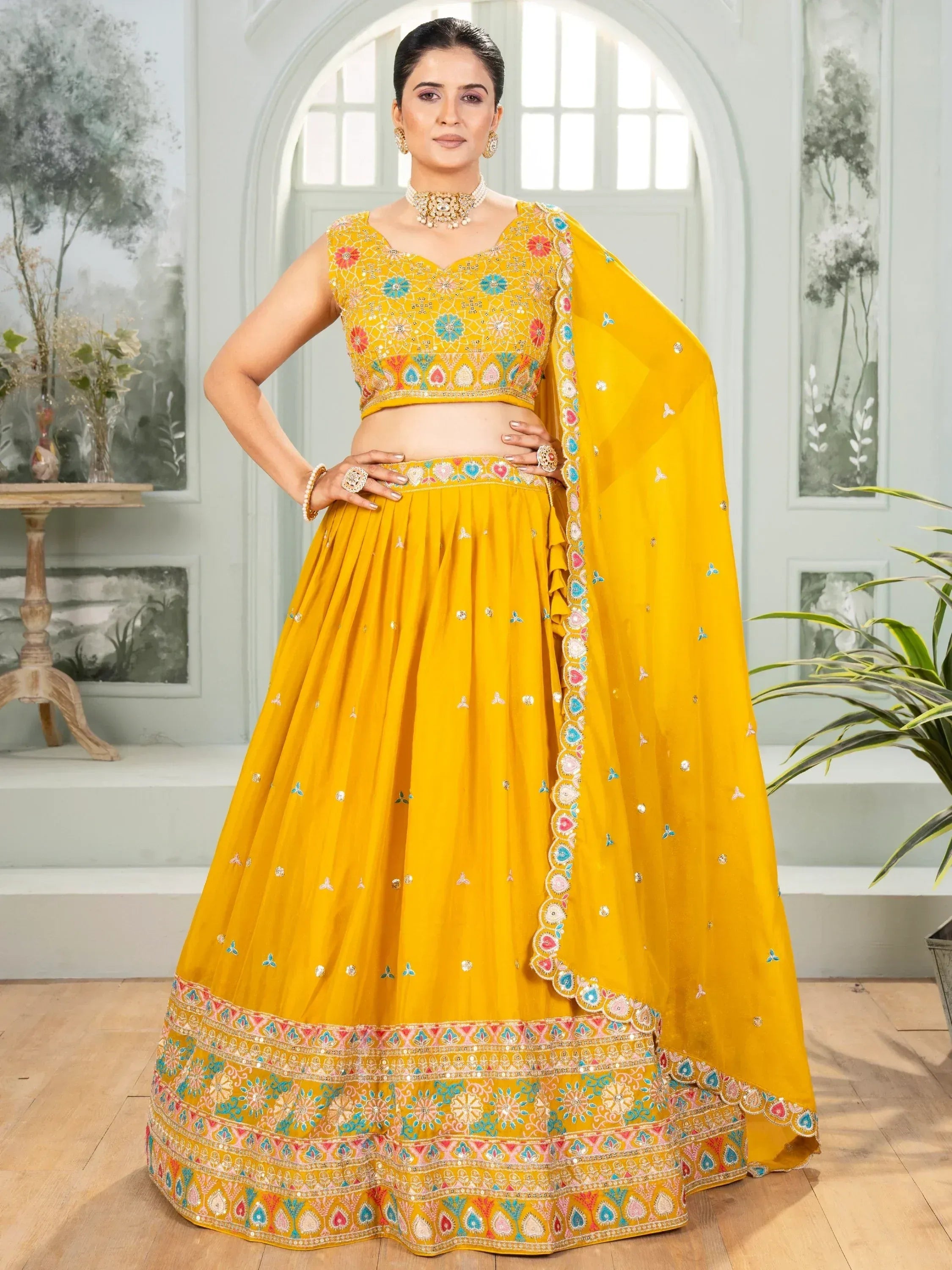 Yellow embroidered lehenga choli with floral motifs and dupatta, perfect for Indian ethnic wear occasions