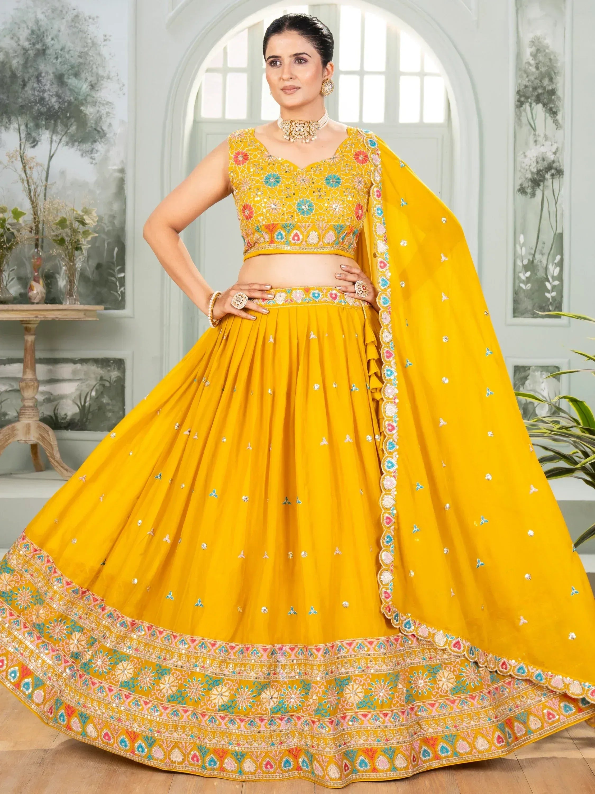 Yellow embroidered lehenga choli with floral motifs and dupatta, perfect for Indian ethnic occasions