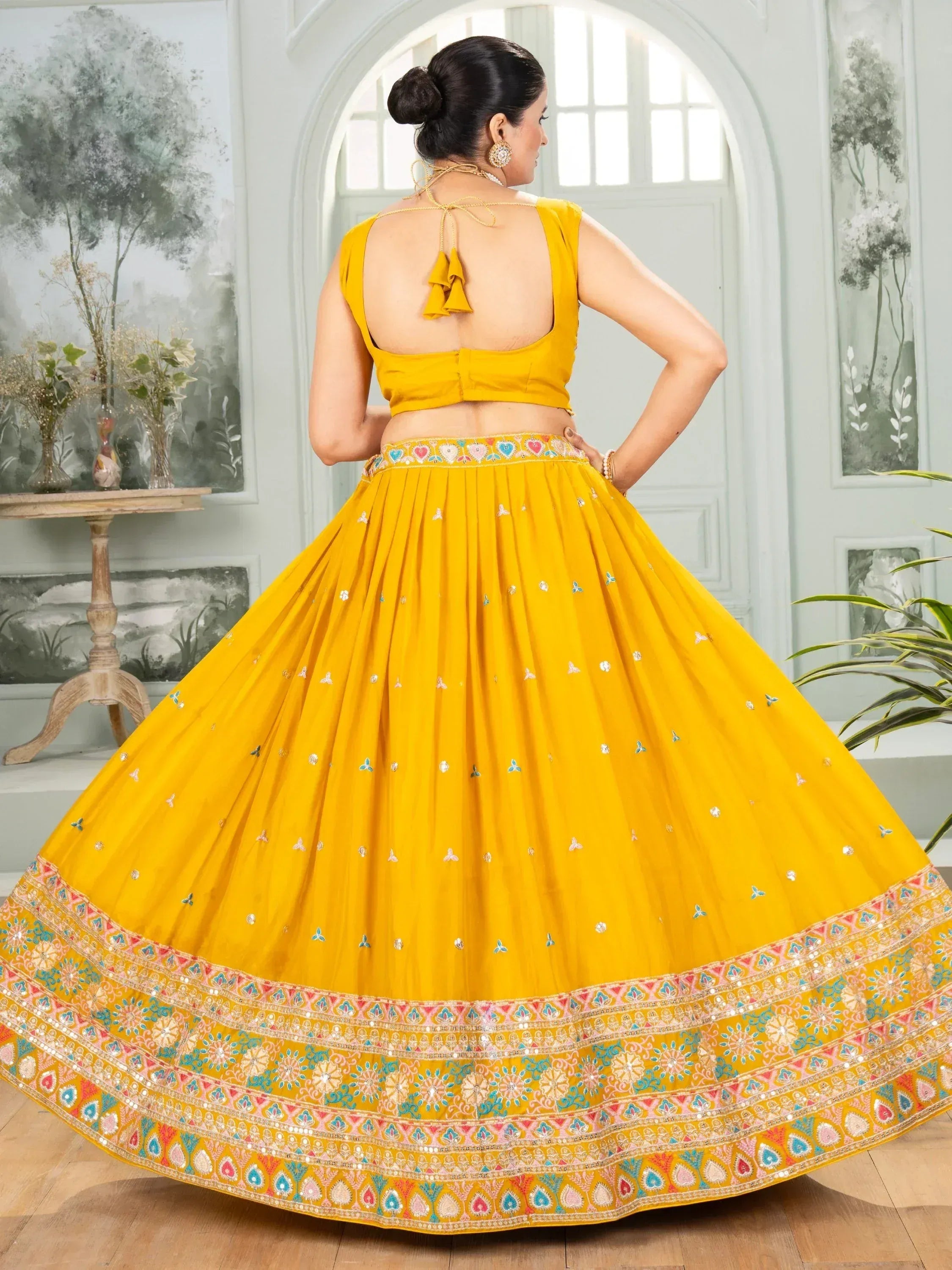 Yellow designer lehenga choli with embroidered skirt and back tie blouse, perfect for Indian ethnic wear