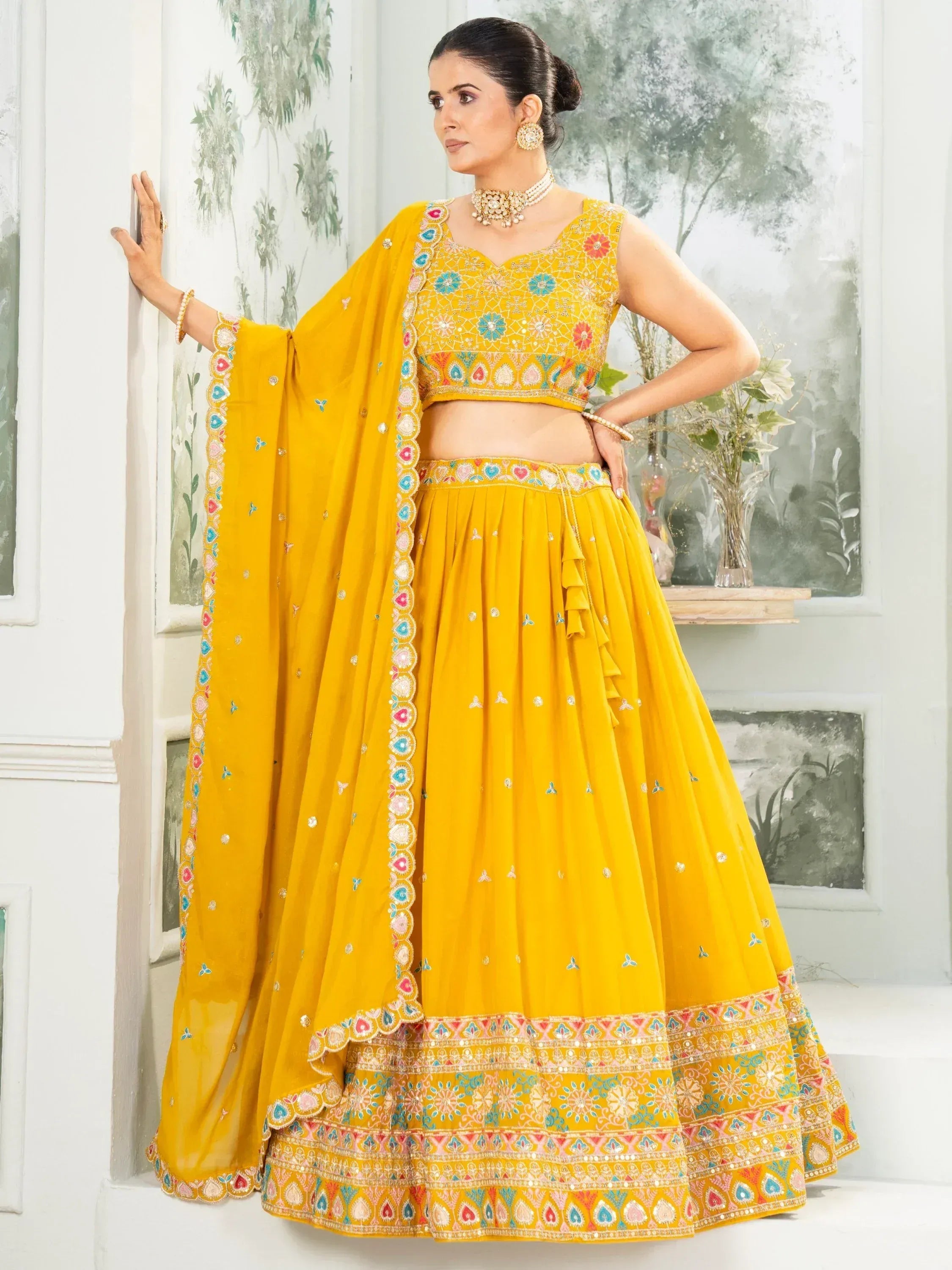 Yellow embroidered lehenga choli with floral motifs and dupatta, perfect for Indian ethnic wear occasions