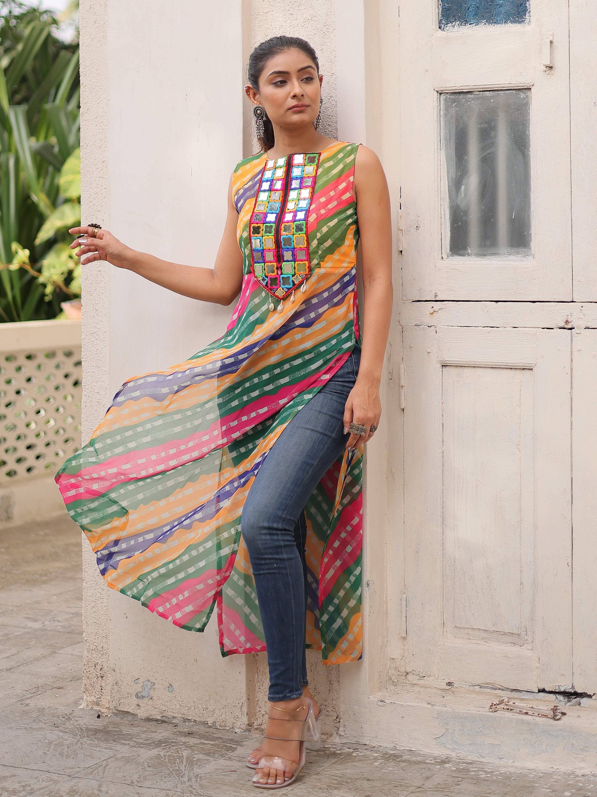 Colorful ethnic kurti with mirror work, paired with jeans, perfect for casual Indian wear.