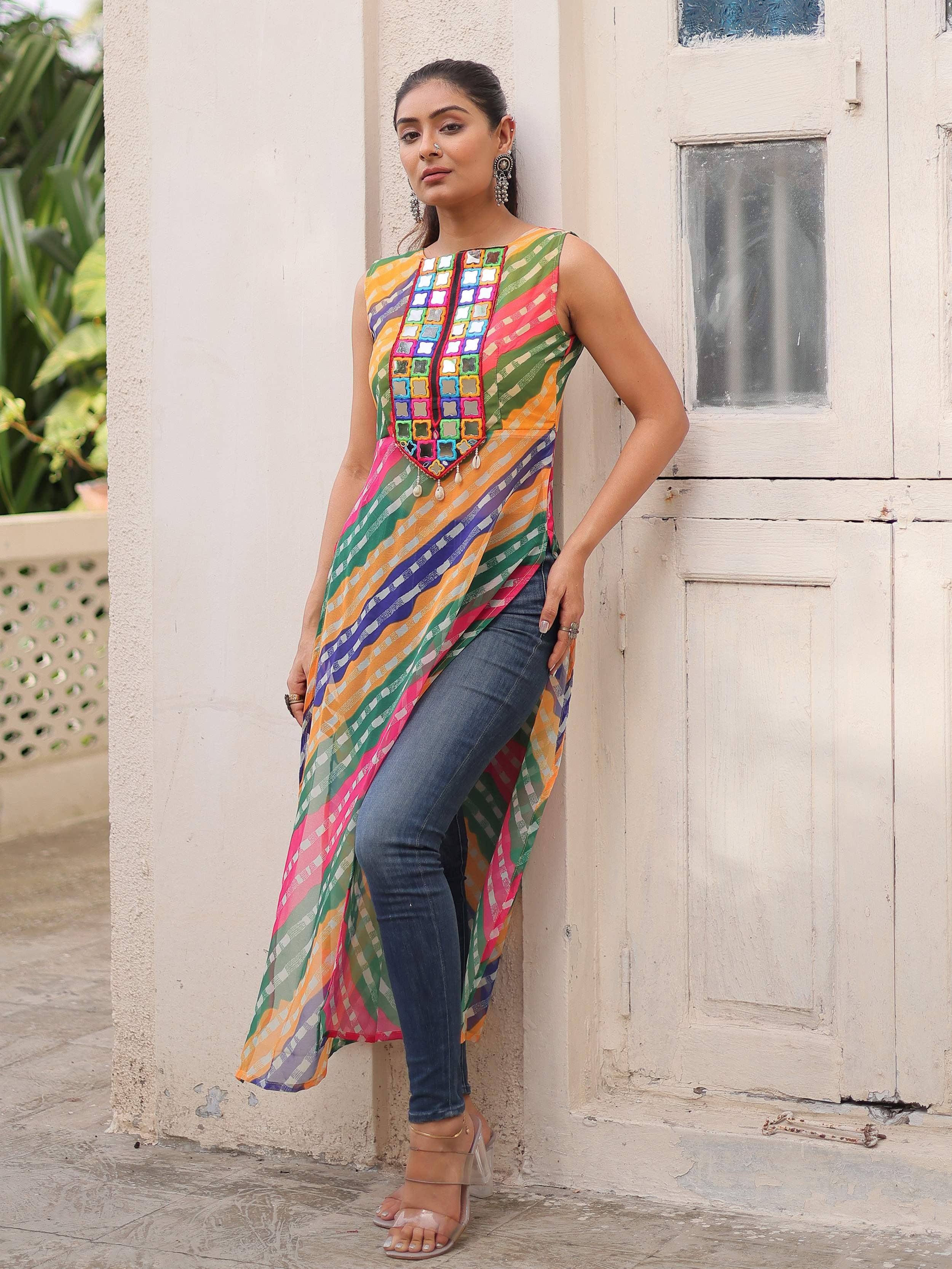 Colorful sleeveless ethnic kurti with mirror work, paired with jeans for casual wear