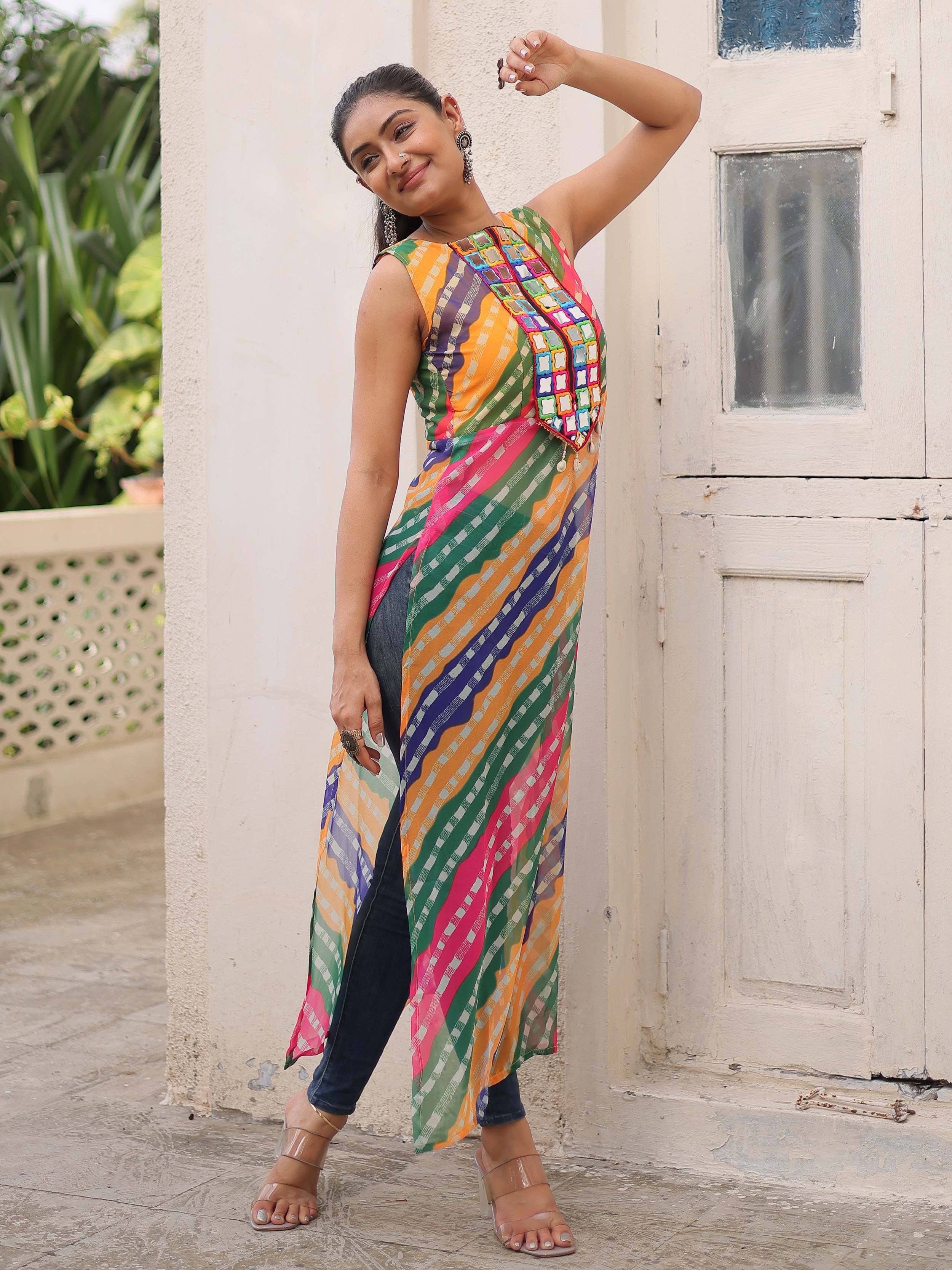 Colorful ethnic gown with mirror work, paired with jeans, perfect for Indian festive wear