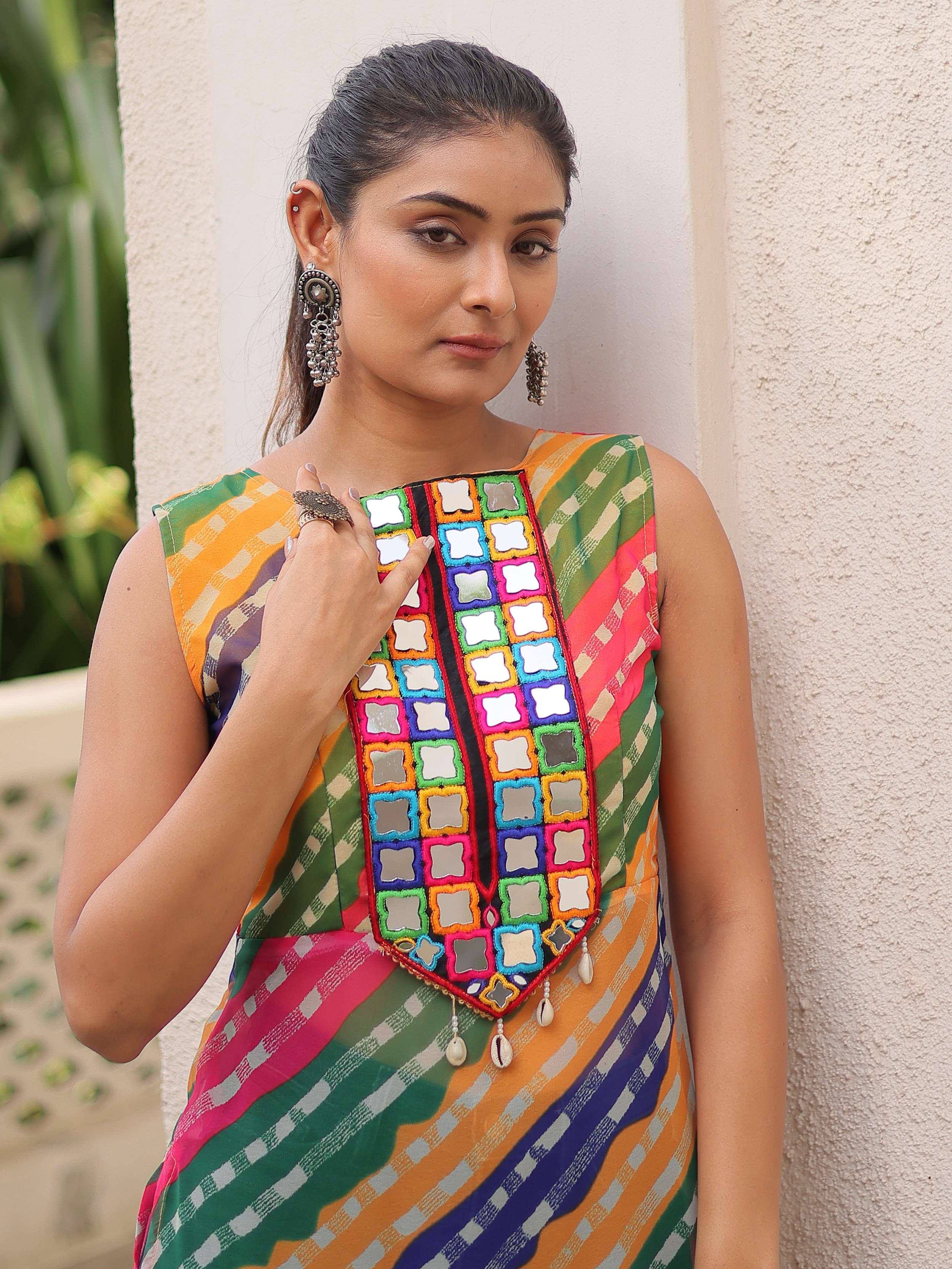 Colorful ethnic dress with mirror work and checkered pattern, styled with jhumka earrings