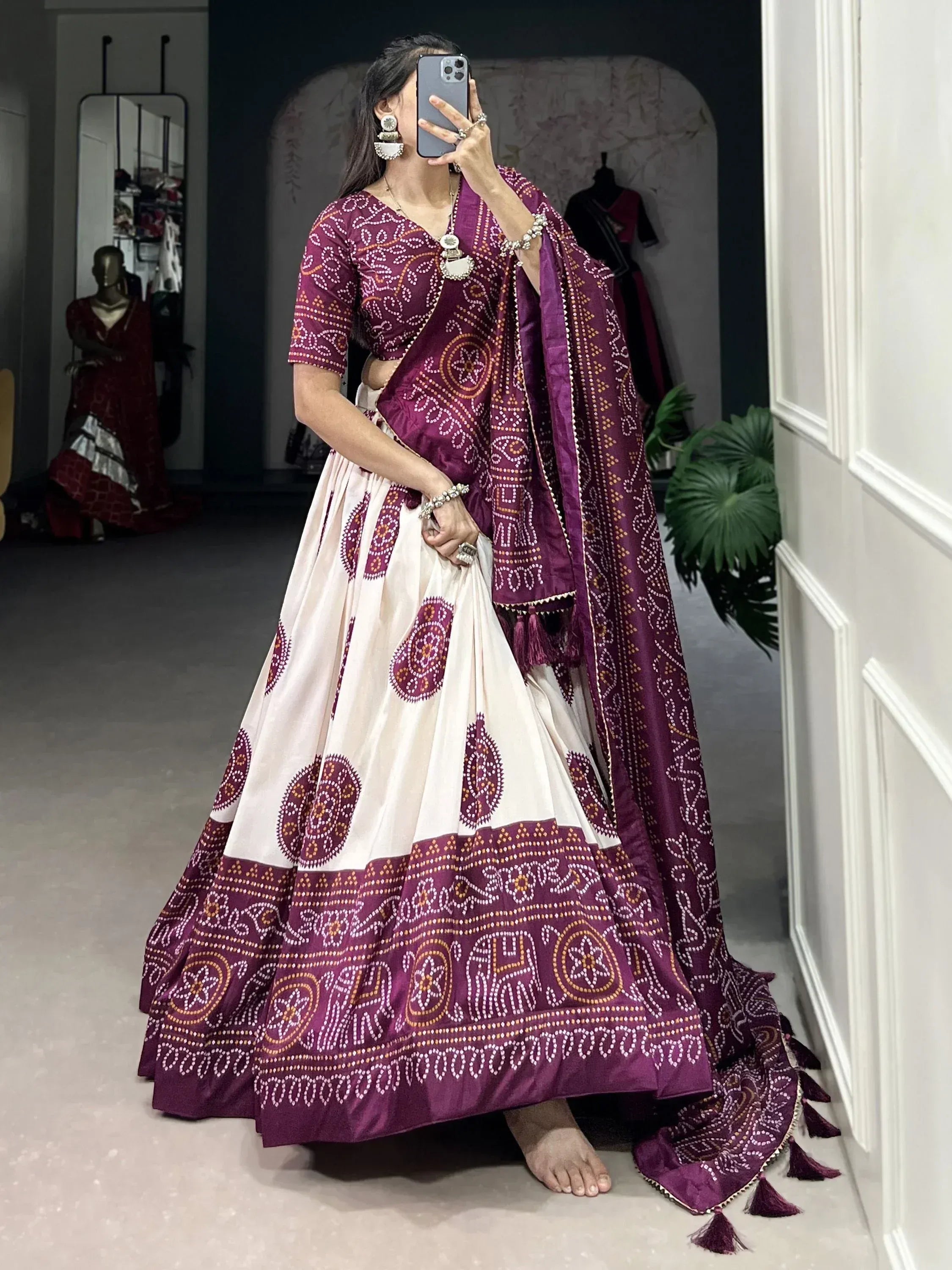 Woman in purple and cream printed lehenga choli with mirror work, perfect for Indian ethnic wear occasions