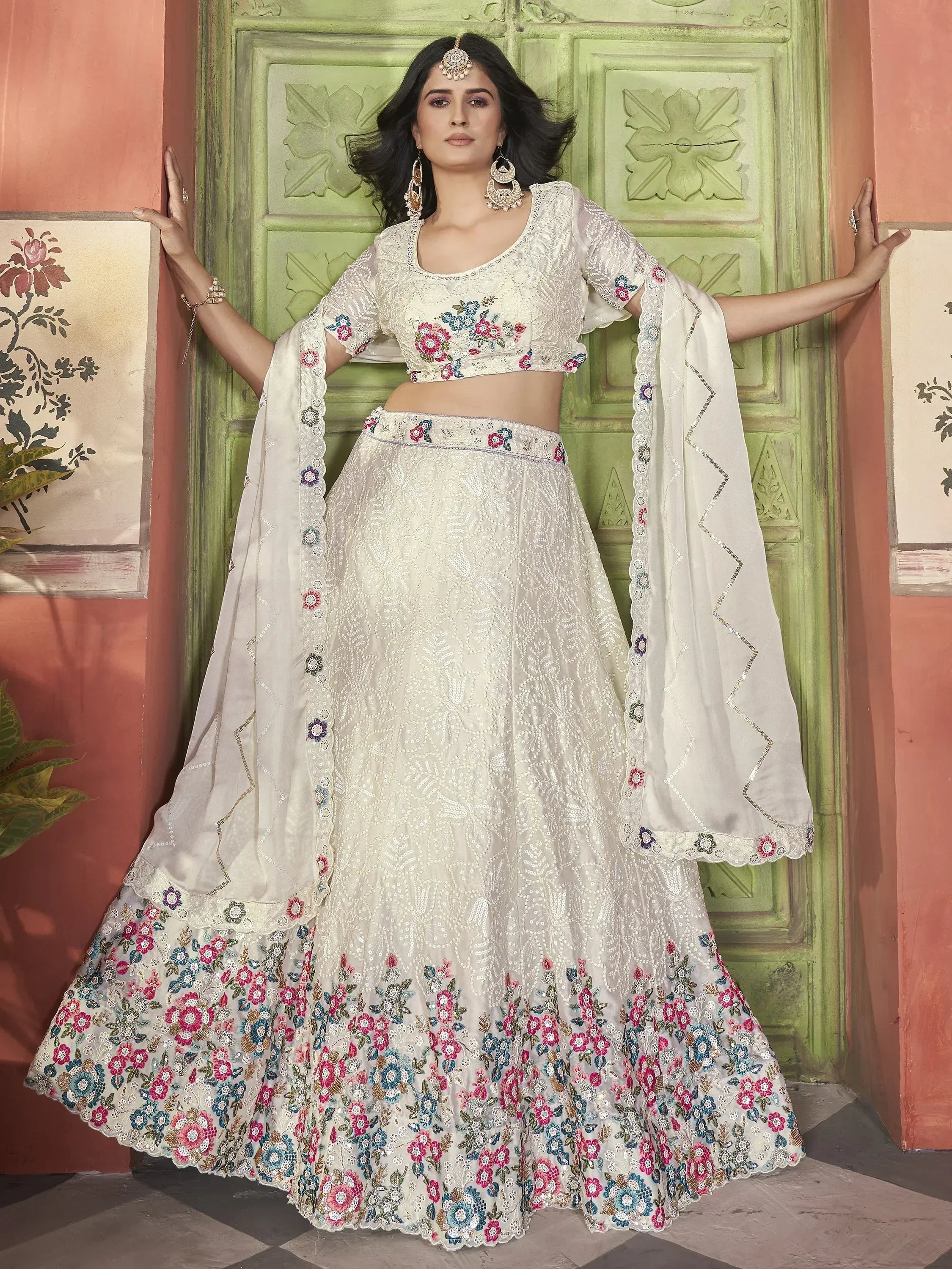 Elegant white lehenga choli with floral embroidery and sequin work, perfect for Indian ethnic occasions.
