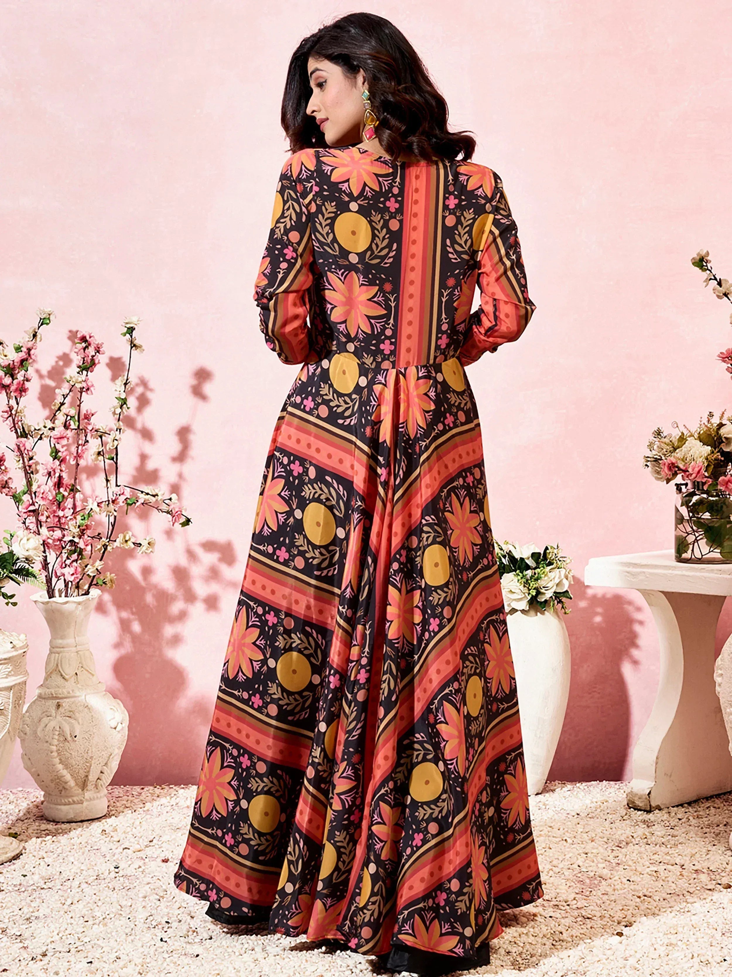 Woman in floral printed ethnic gown with long sleeves, perfect for Indian occasions and festive wear.