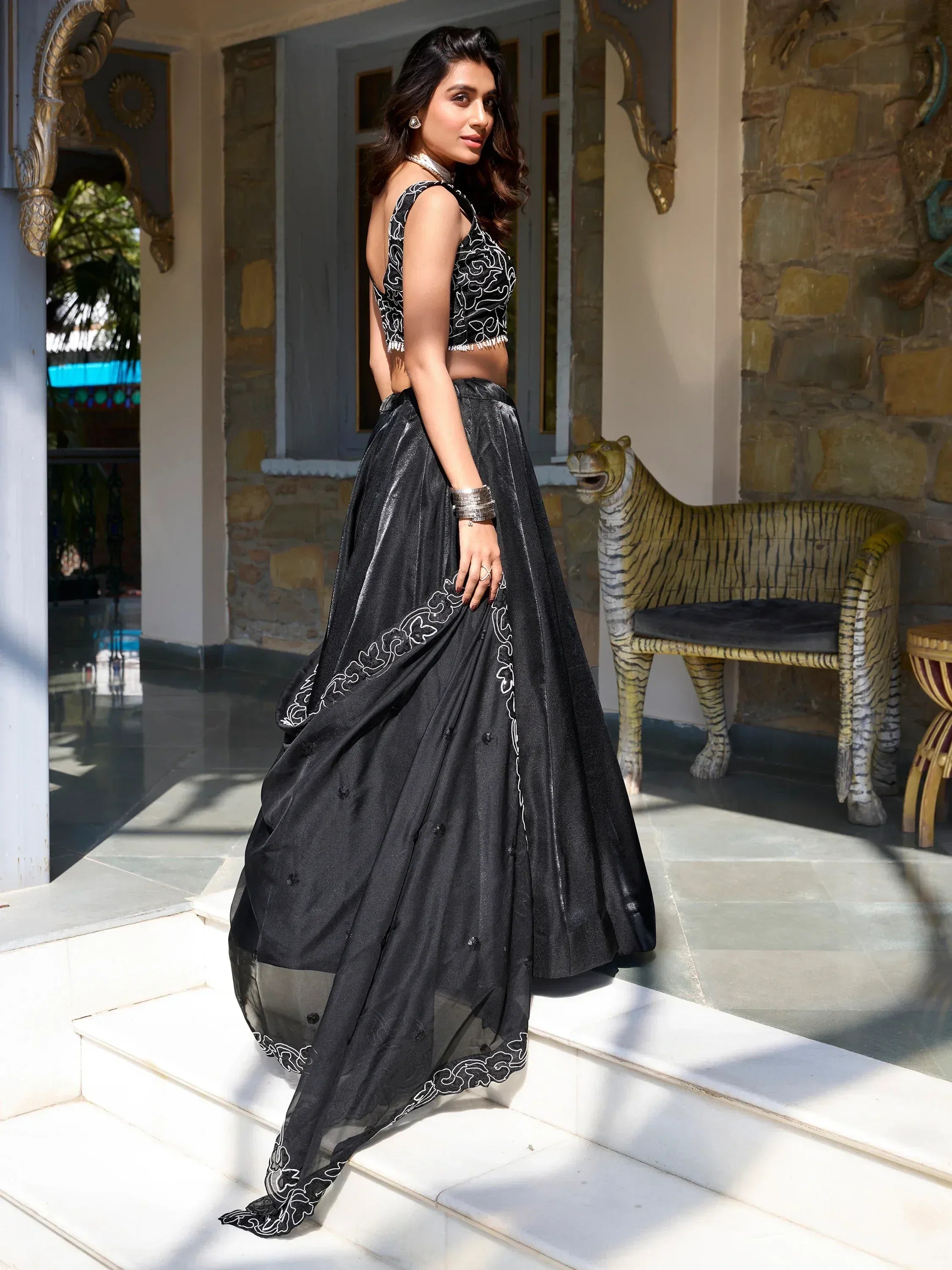 Black embroidered lehenga choli with white floral detailing, perfect for Indian ethnic wear events