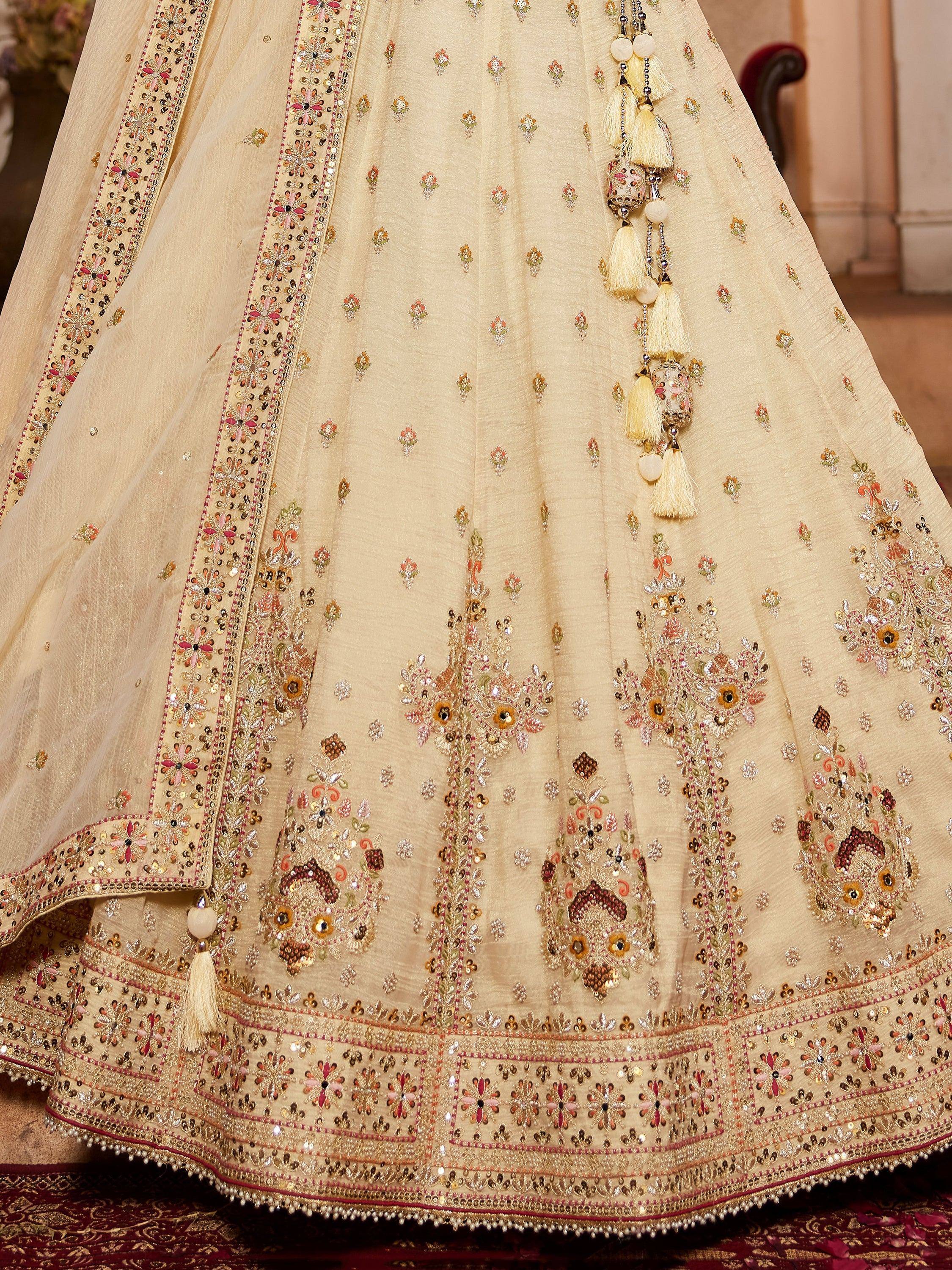 Cream embroidered lehenga with floral motifs, sequins, and tassels for Indian ethnic wear