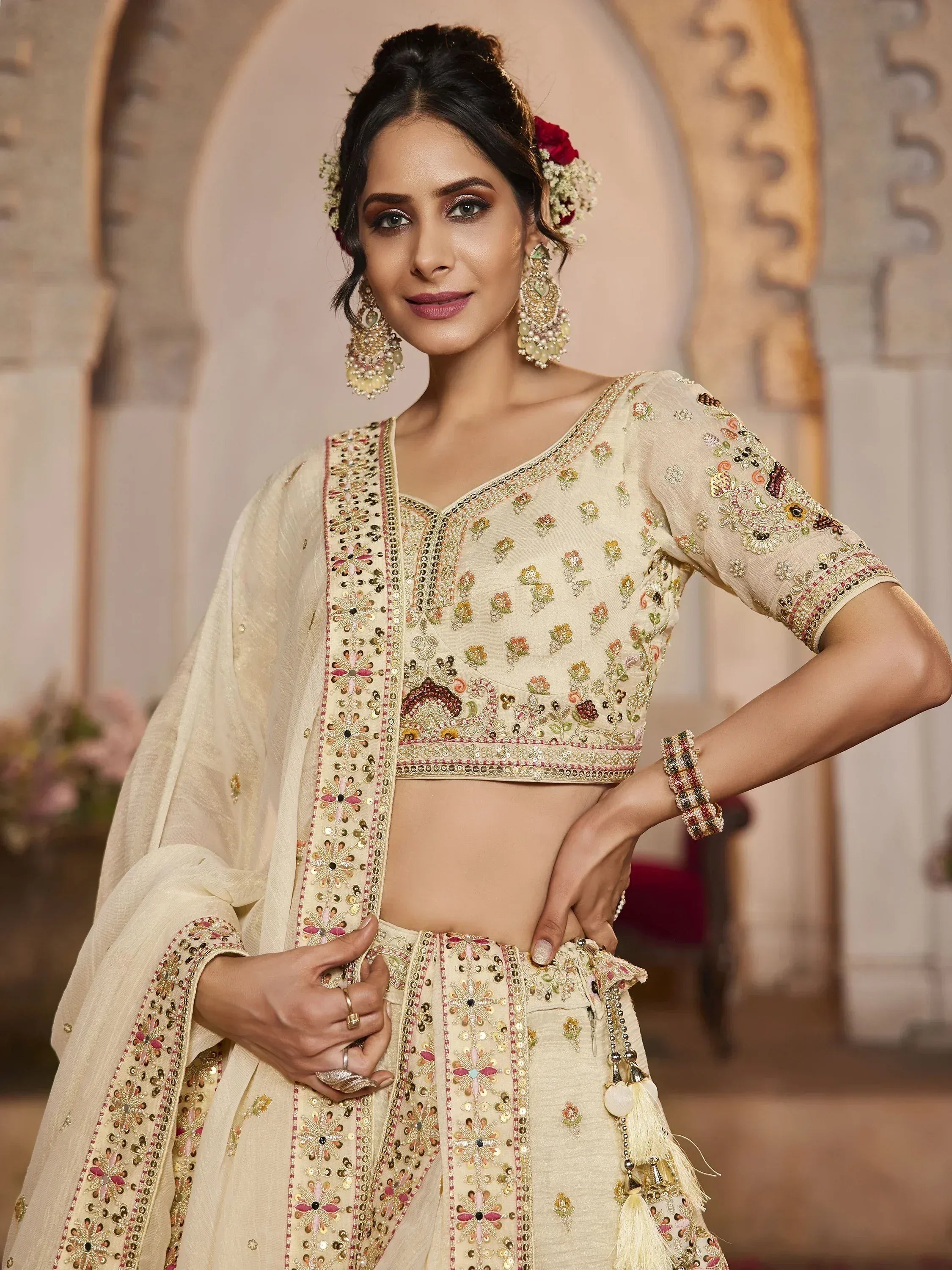 Elegant cream embroidered lehenga choli with floral motifs, perfect for Indian weddings and festive occasions.