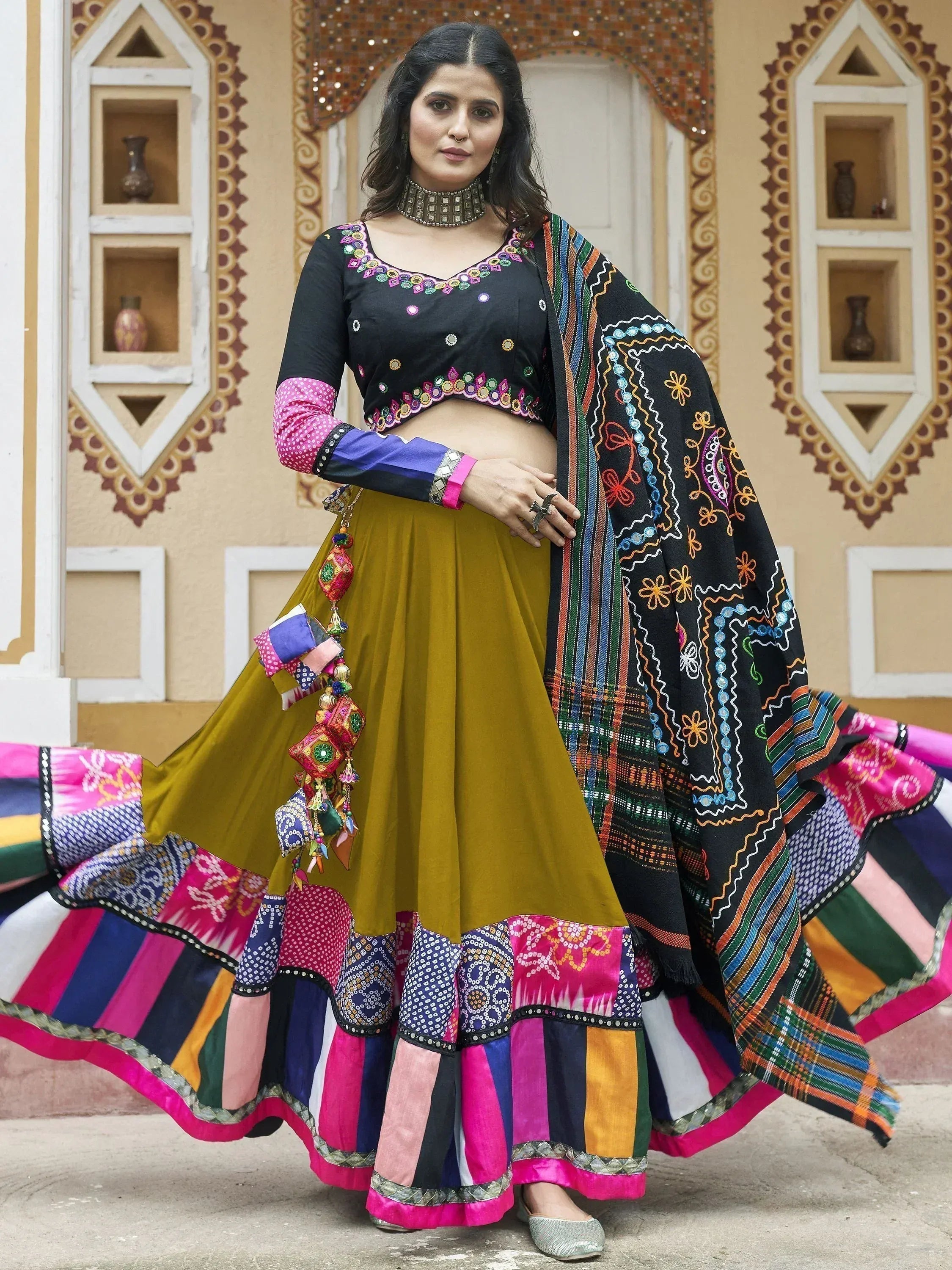 Colorful Indian ethnic lehenga choli with mirror work, embroidered dupatta, and patchwork skirt for festive occasions