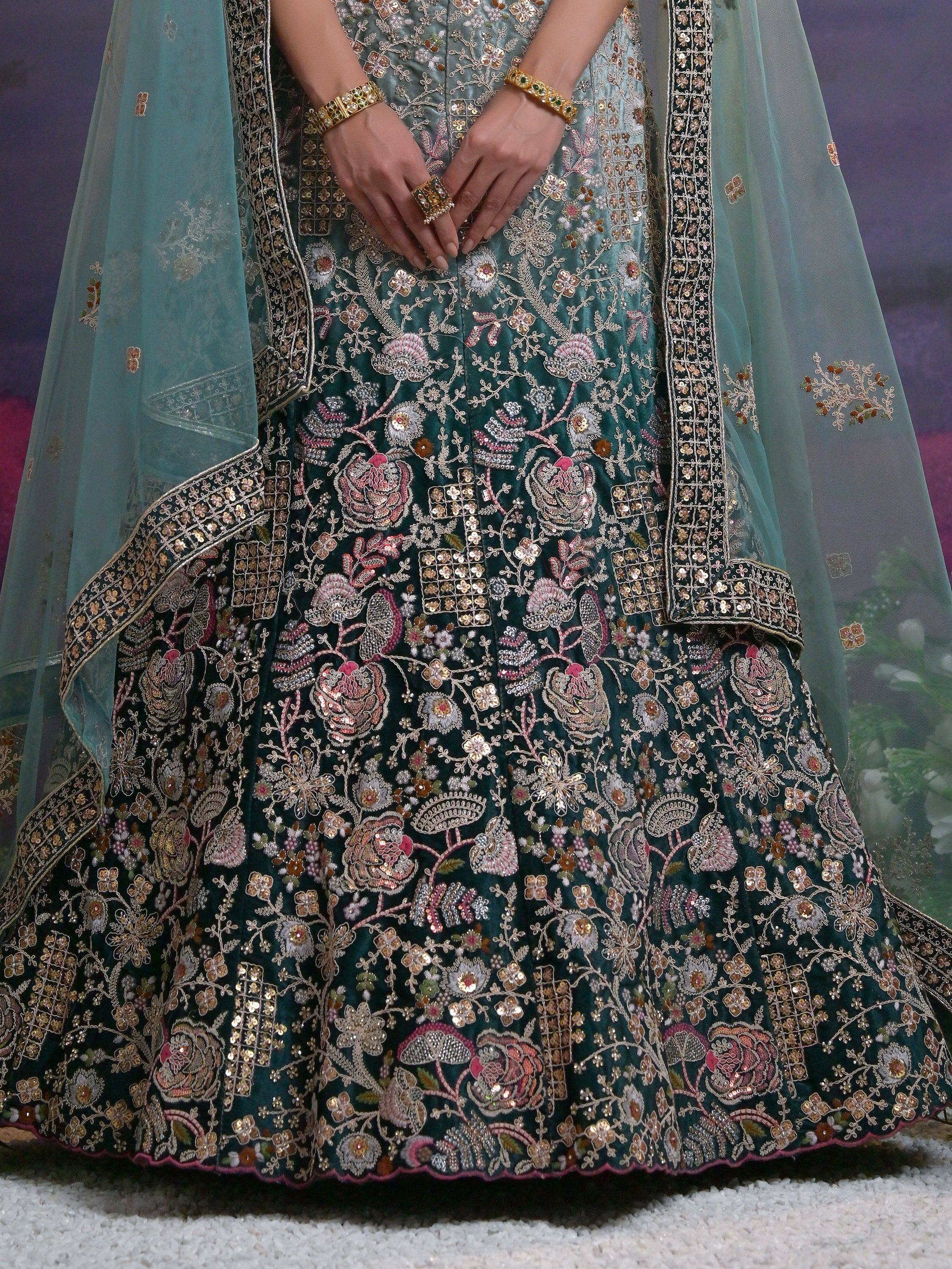 Emerald green embroidered lehenga choli with floral motifs and sheer dupatta, perfect for Indian weddings