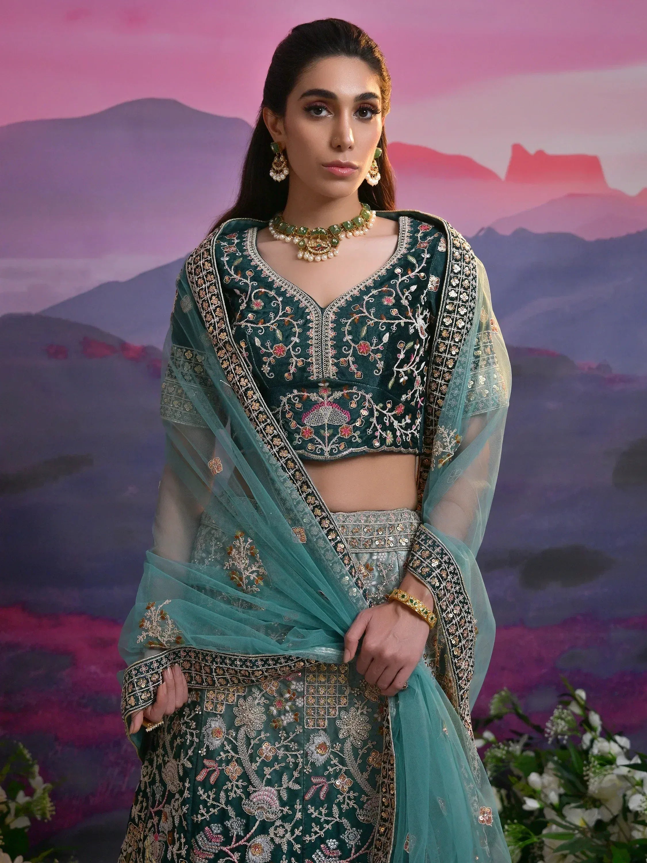Elegant green embroidered lehenga choli with floral detailing and sheer dupatta, perfect for Indian ethnic occasions.