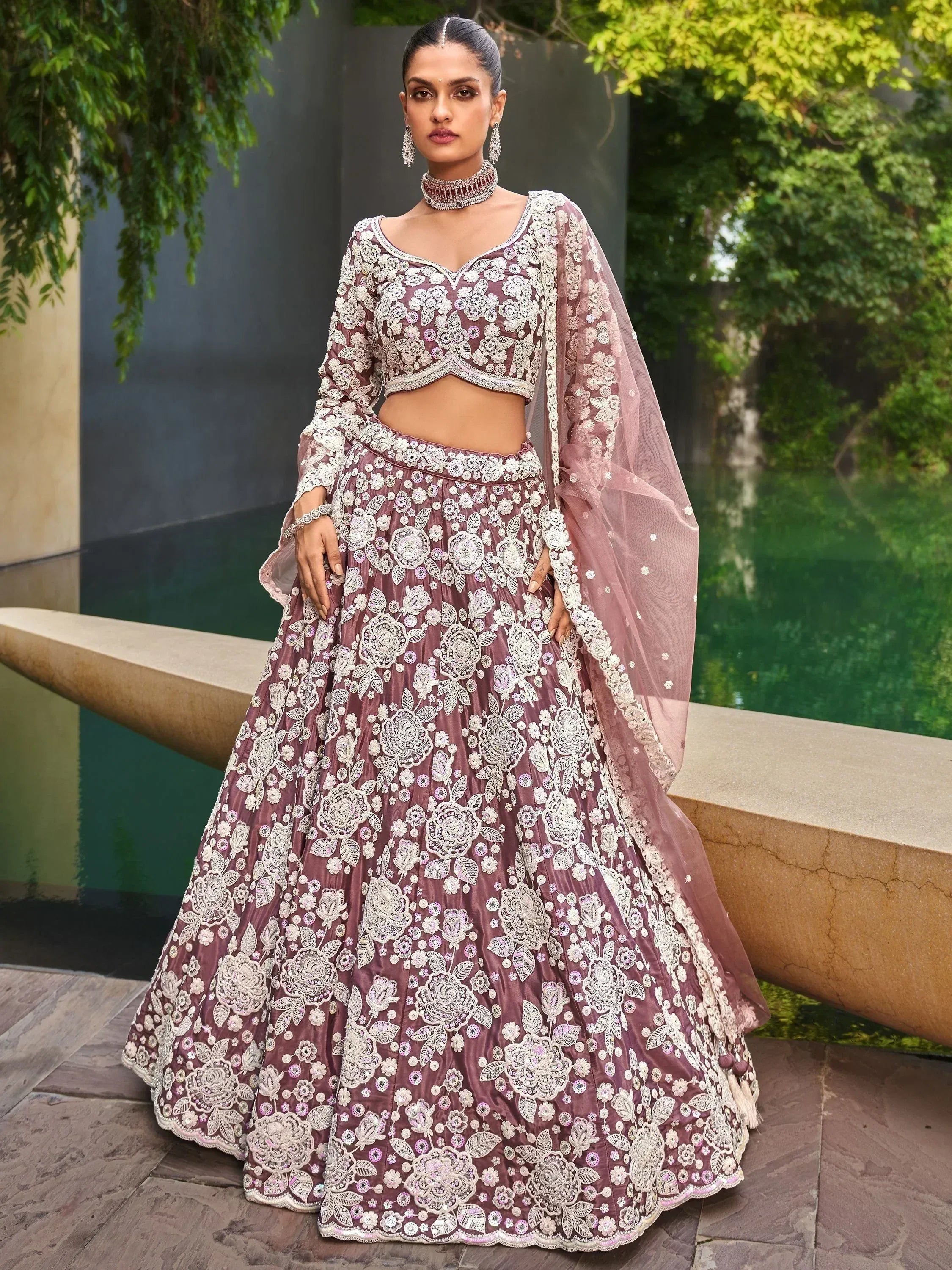 Elegant mauve lehenga choli with intricate white floral embroidery, perfect for Indian weddings and festive occasions.