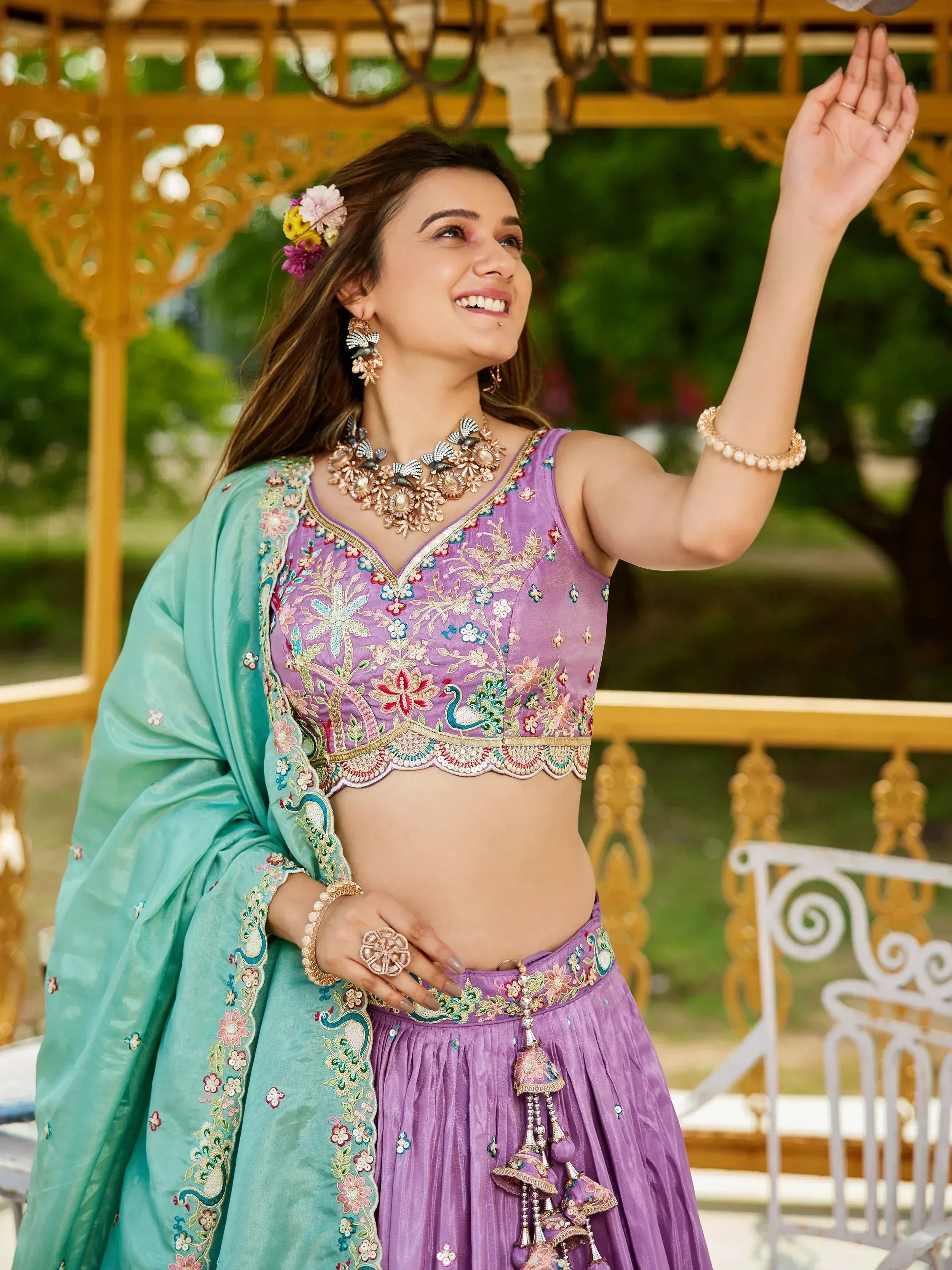 Woman in purple embroidered lehenga choli with floral dupatta, perfect for Indian ethnic occasions