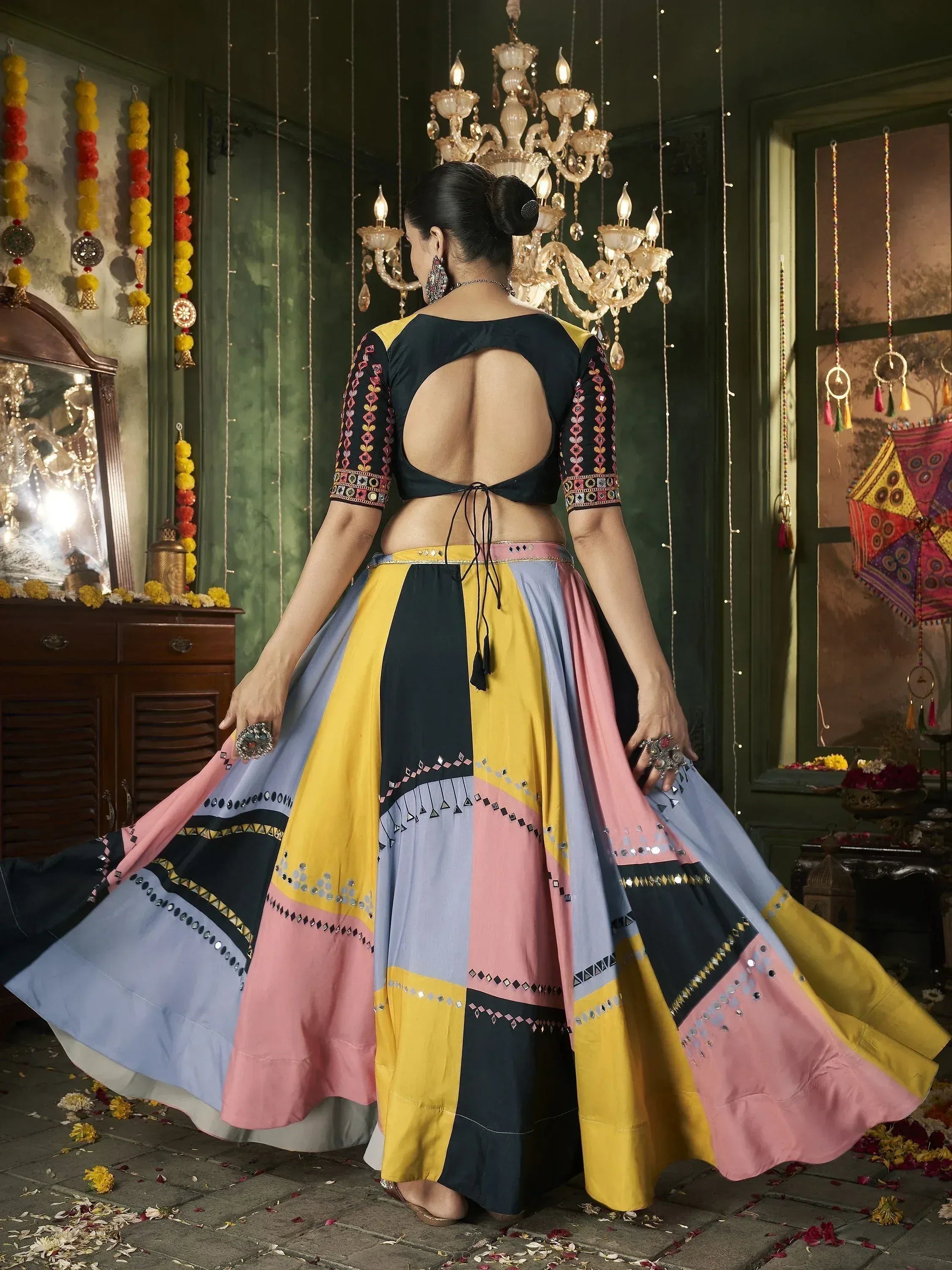 Colorful ethnic lehenga choli with backless blouse and patchwork skirt, perfect for festive occasions.