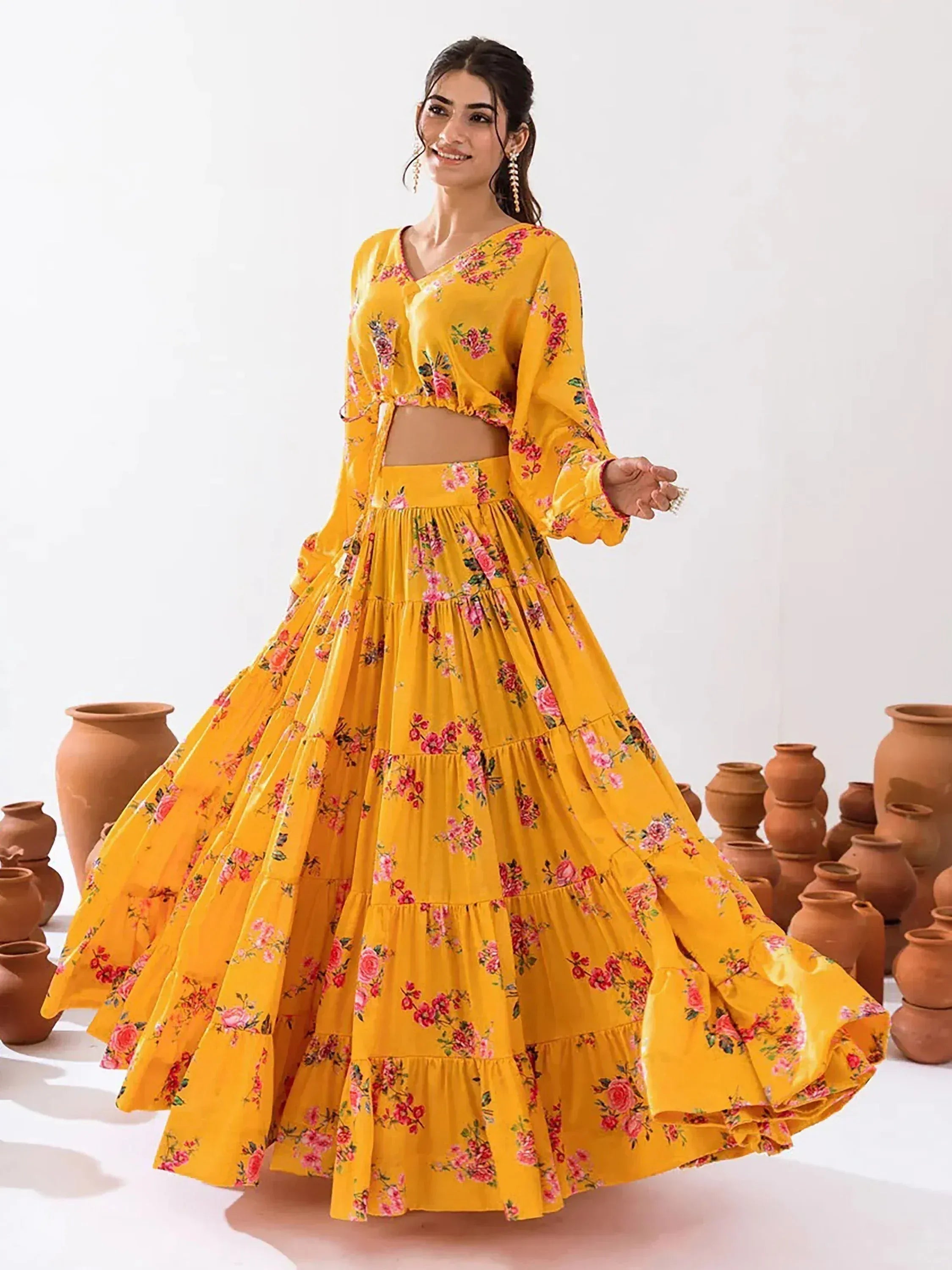 Yellow floral lehenga choli with tiered skirt, perfect for Indian ethnic wear and festive occasions.