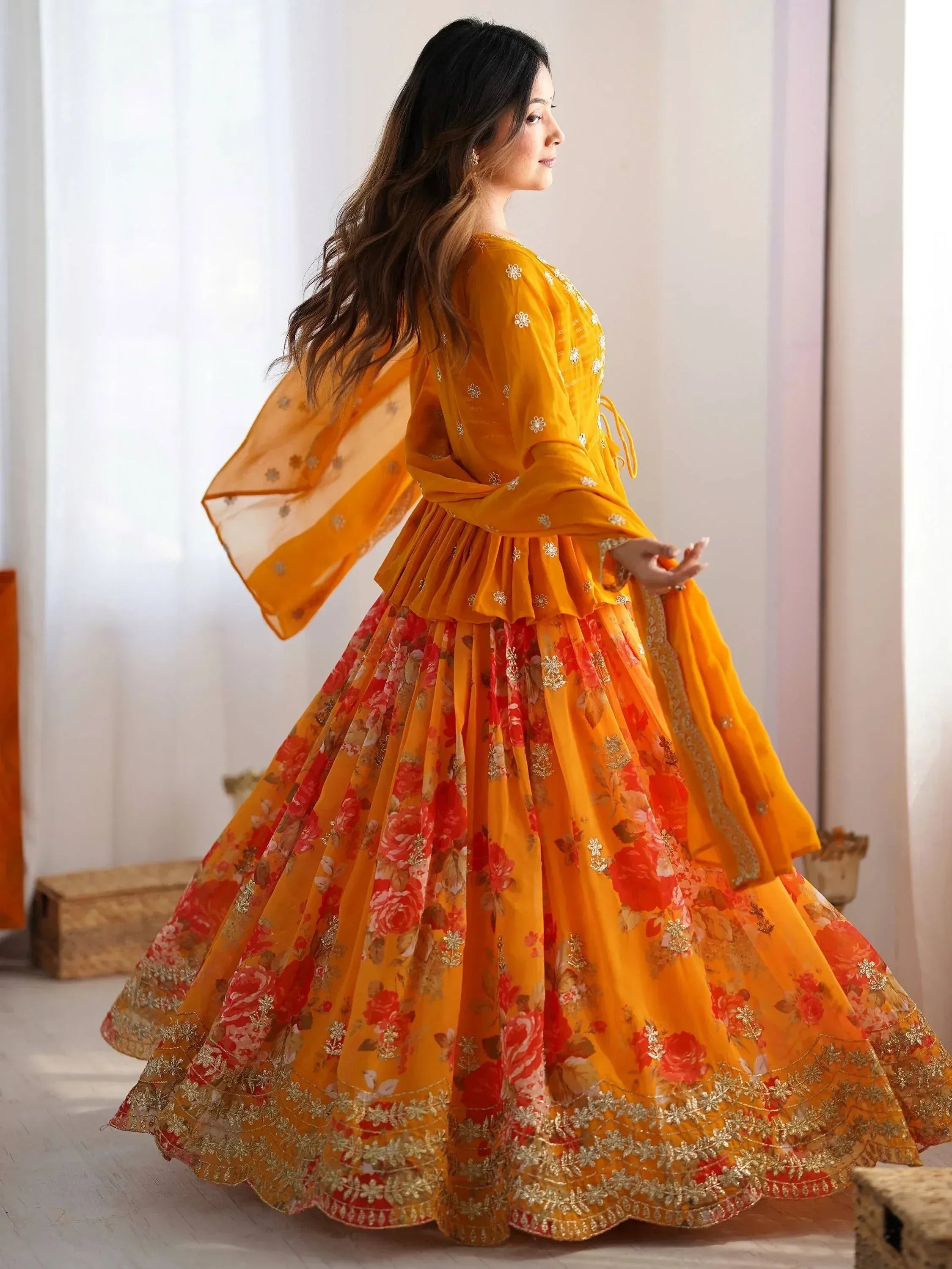 Woman in vibrant yellow floral lehenga choli with gold embroidery, perfect for Indian ethnic wear occasions