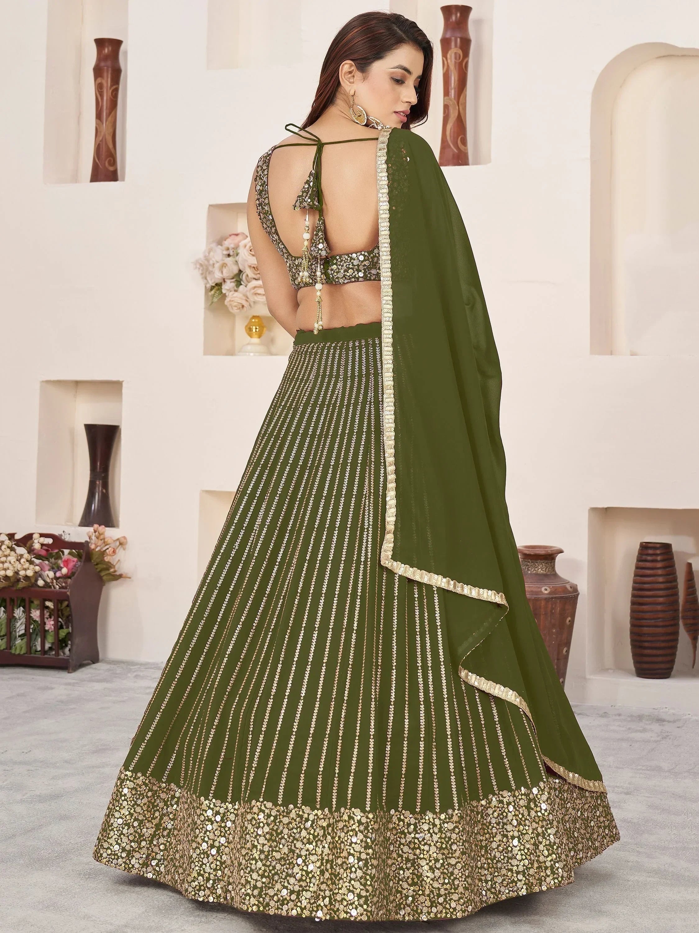 Olive green designer lehenga choli with gold embroidery and sequin work, back view