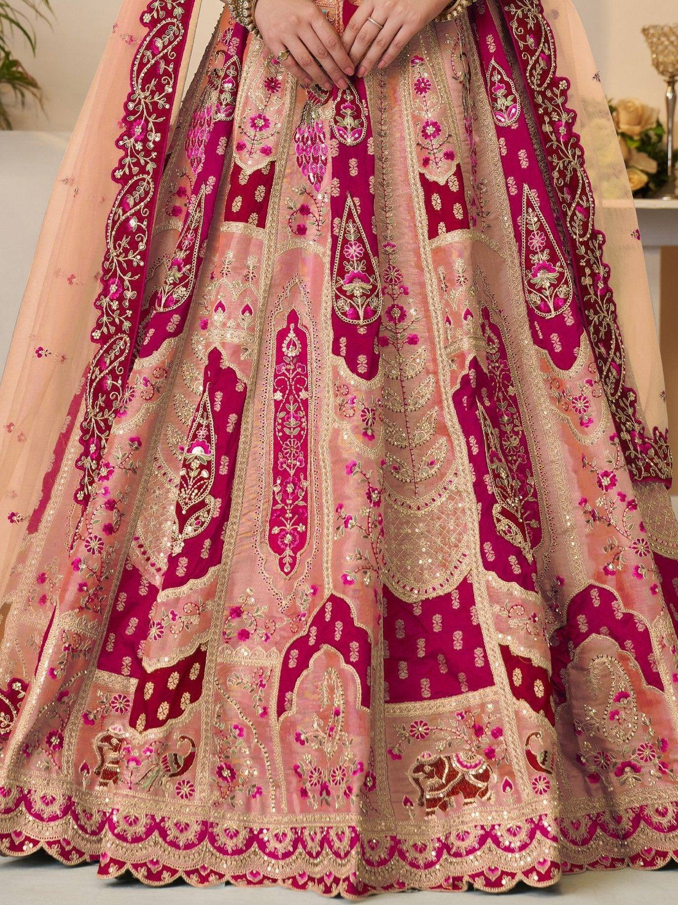 Pink and magenta embroidered lehenga with gold detailing and floral motifs, perfect for Indian weddings.