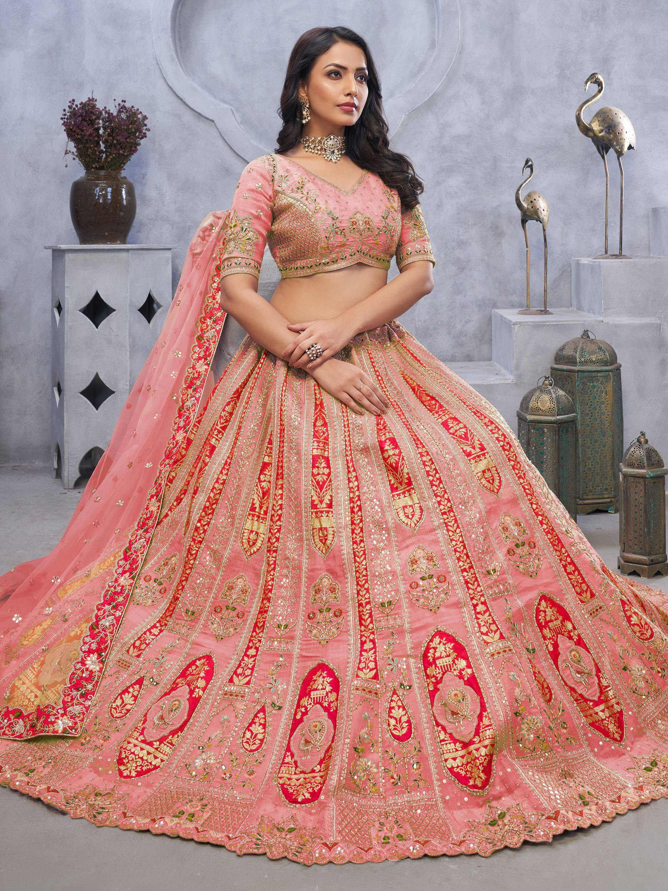 Pink and red embroidered lehenga choli with gold detailing, perfect for Indian weddings and festive occasions.
