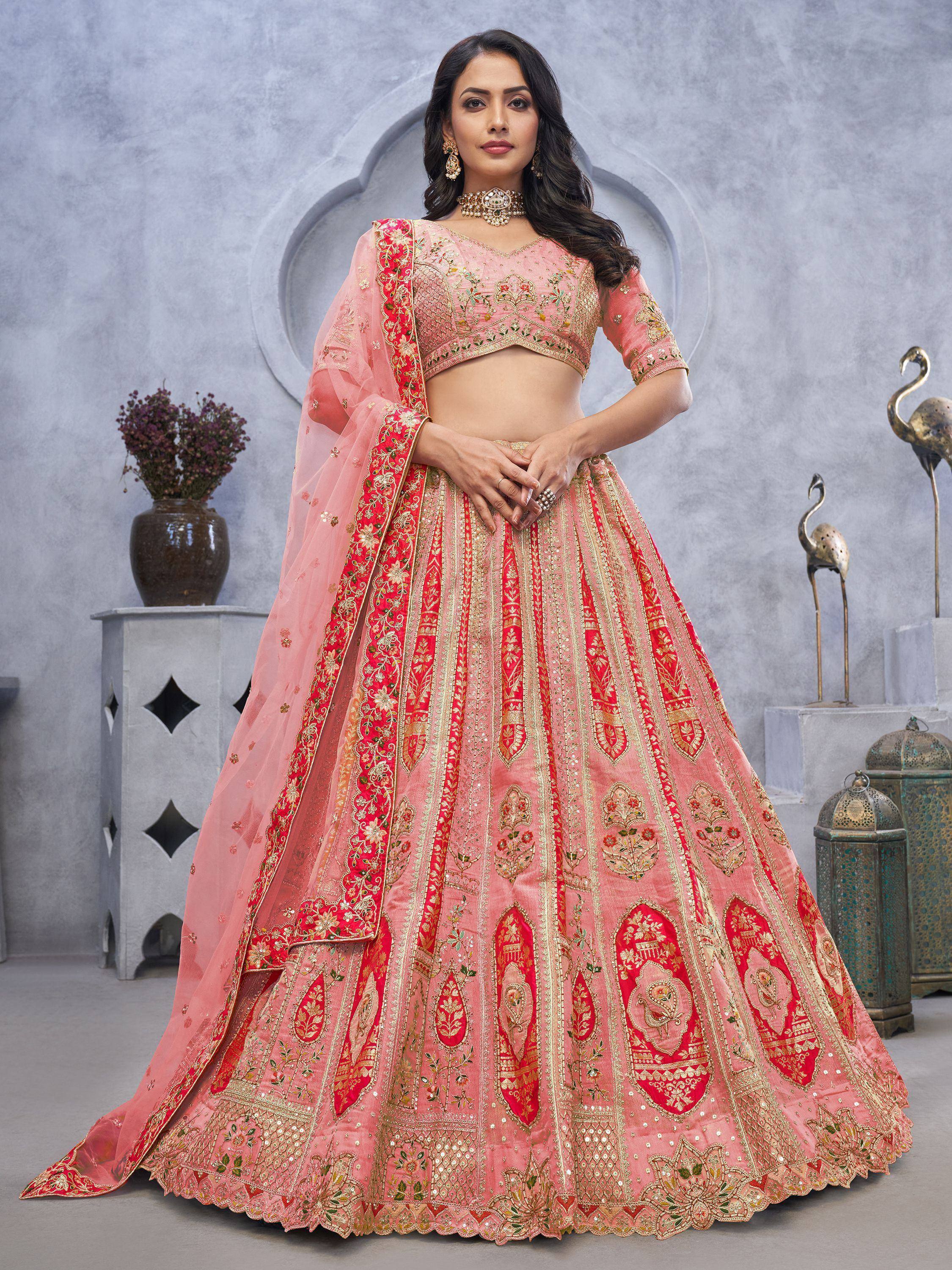Pink and red embroidered lehenga choli with gold detailing, perfect for Indian weddings and festive occasions.