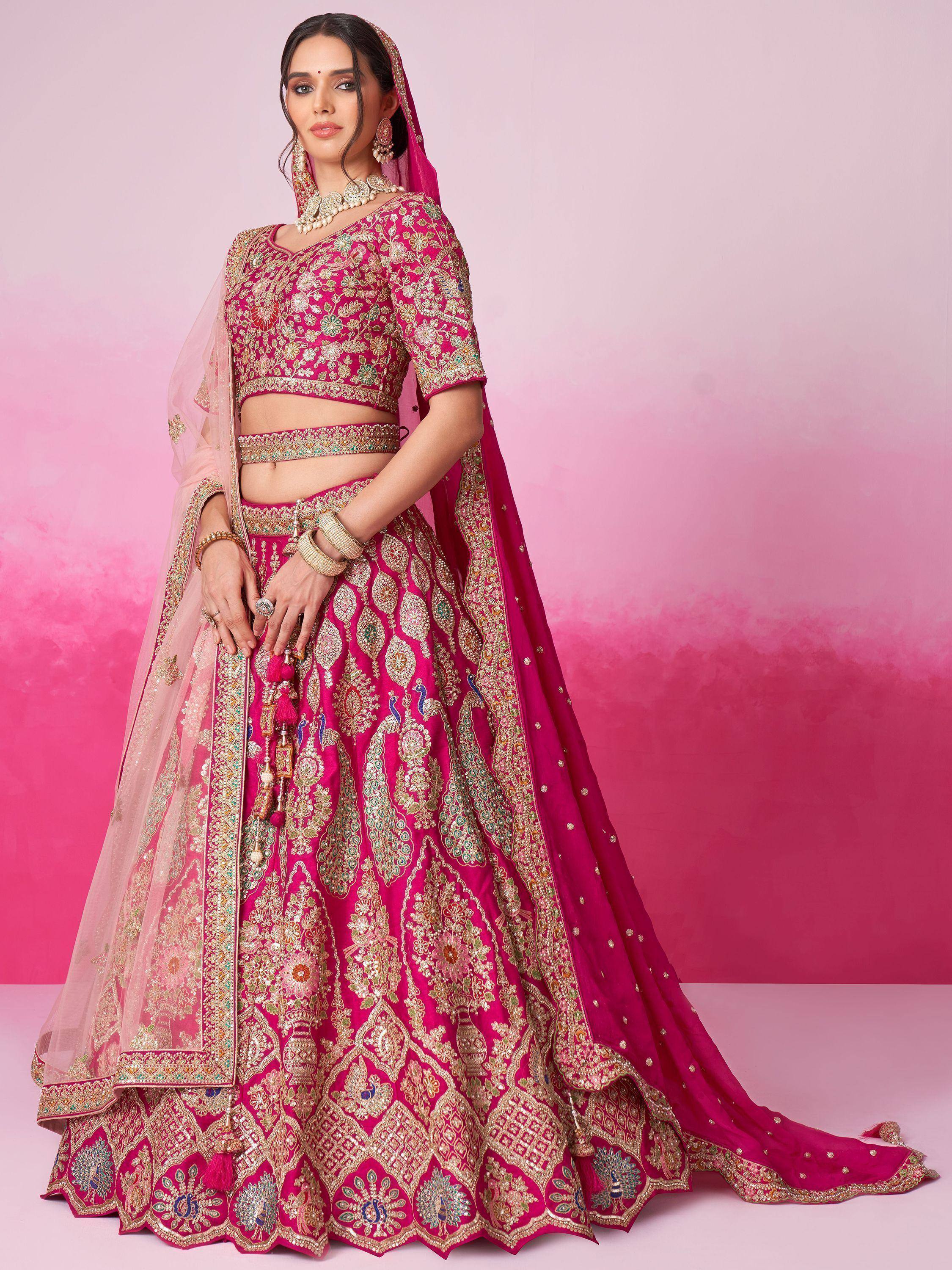 Pink embroidered lehenga choli with peacock motifs, perfect for Indian weddings and festive occasions.