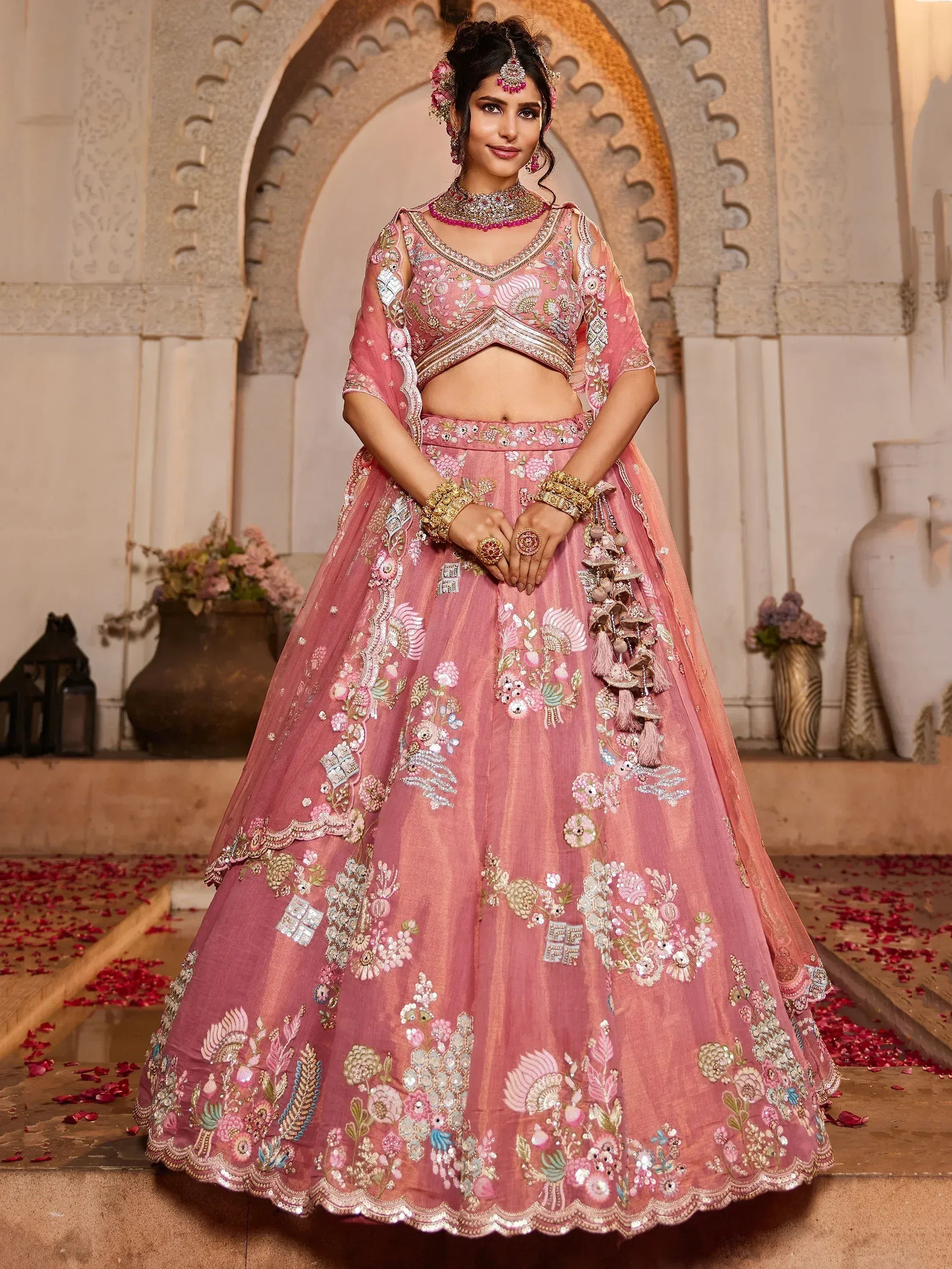 Pink embroidered lehenga choli with floral motifs, perfect for Indian weddings and festive occasions