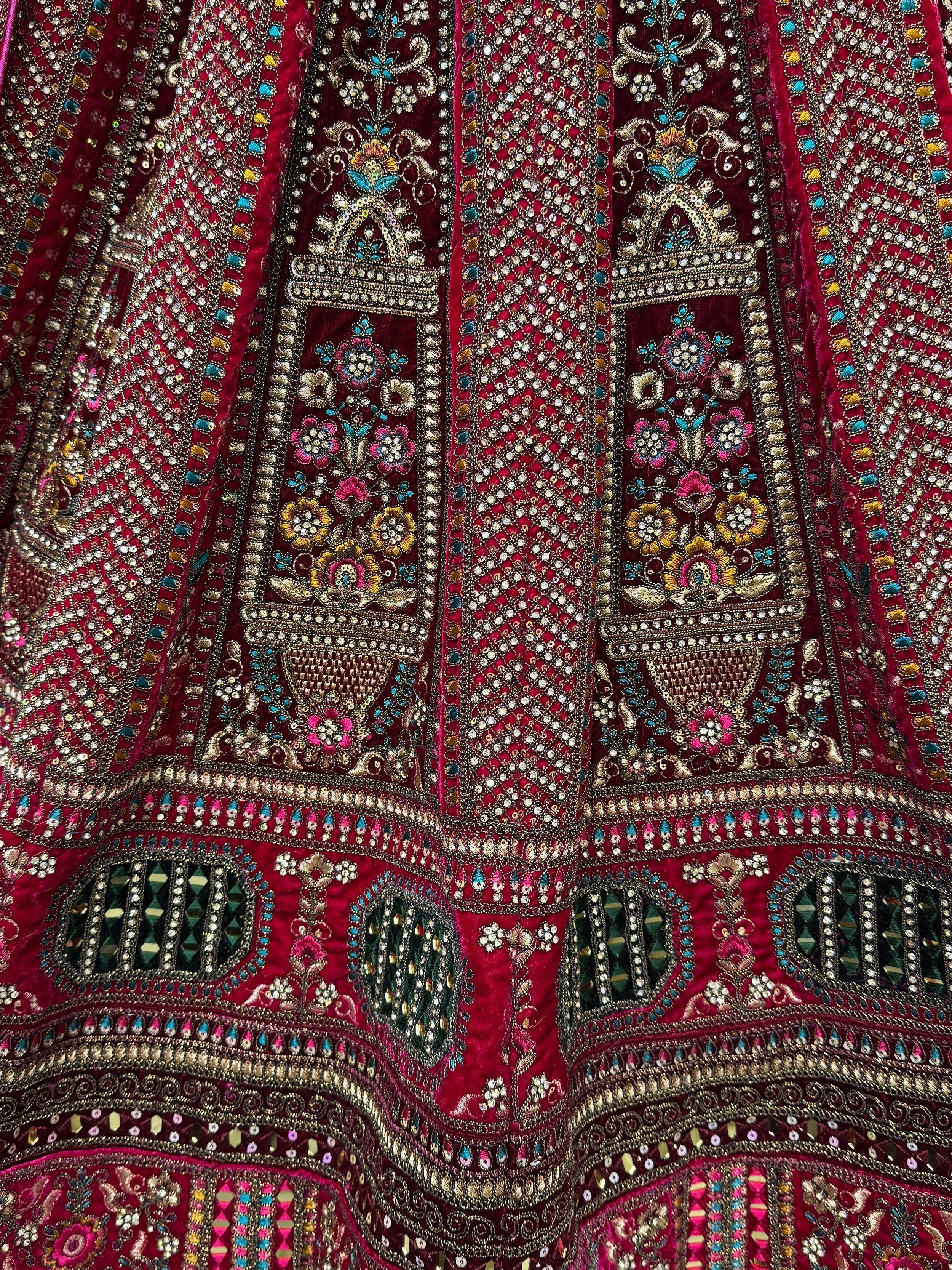 Richly embroidered maroon lehenga with floral motifs, sequins, and mirror work for Indian ethnic wear
