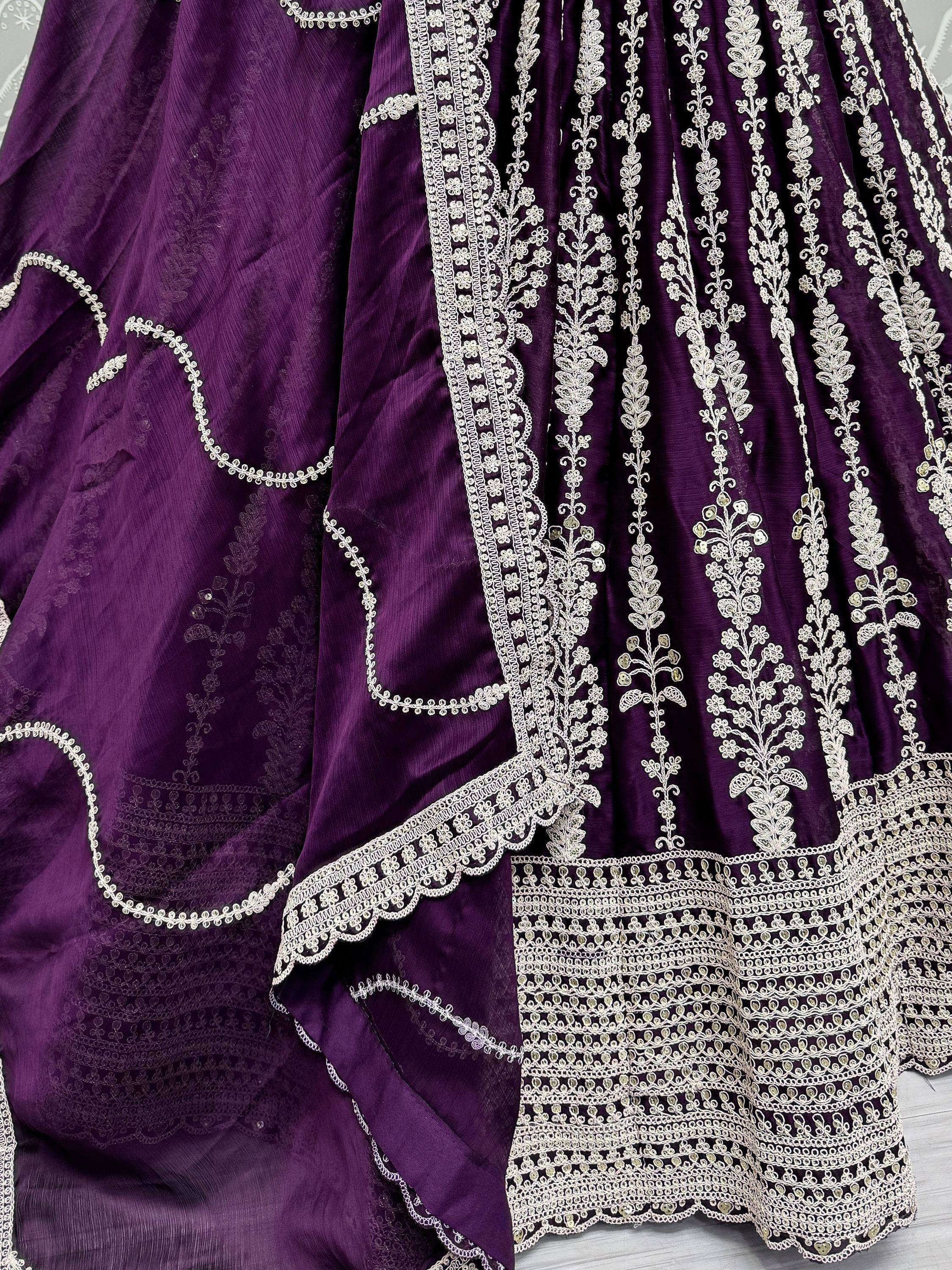 Purple ethnic gown with intricate white floral embroidery and sequin detailing, perfect for Indian celebrations.