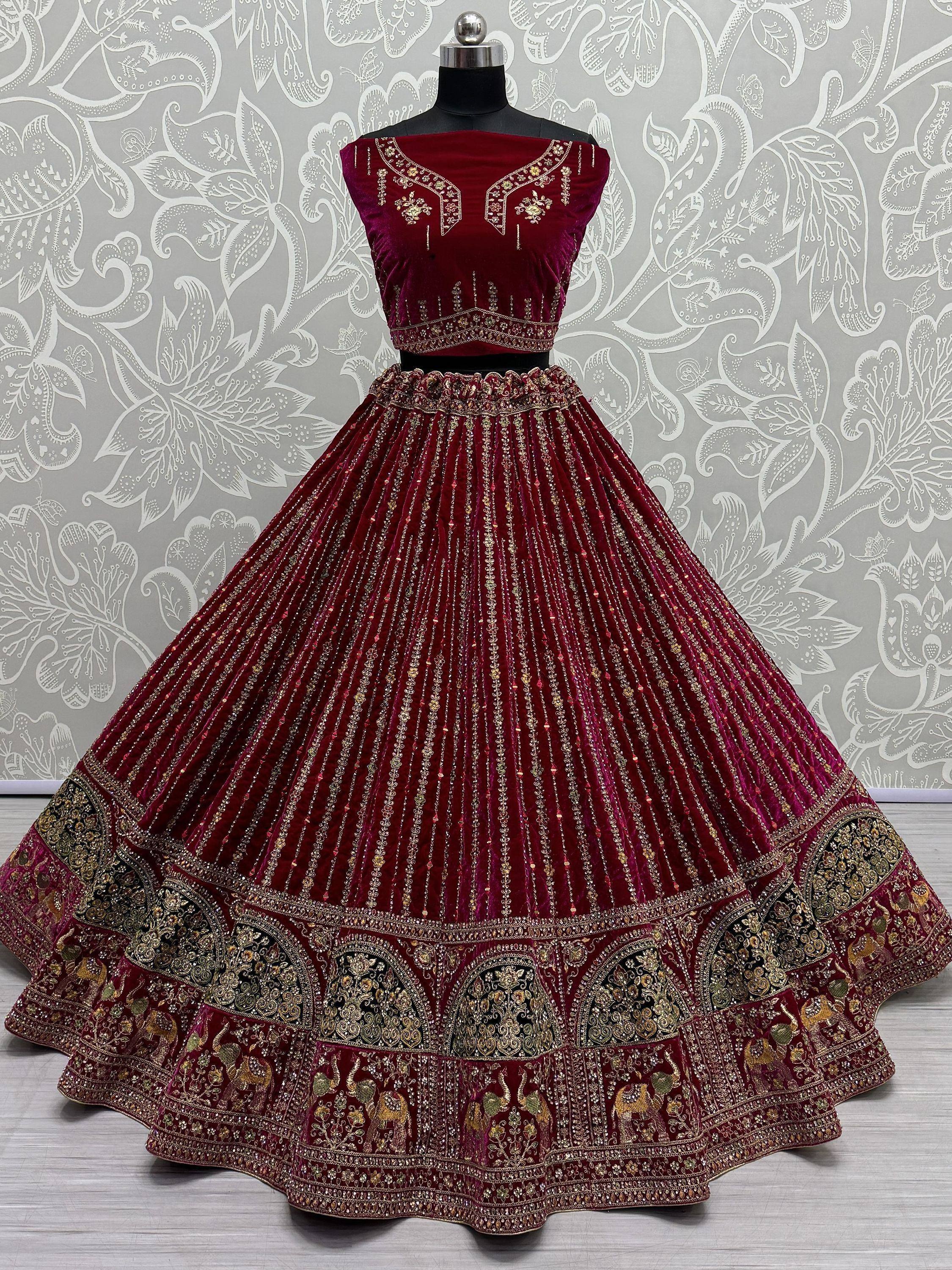 Burgundy velvet lehenga choli with gold embroidery and elephant motifs, perfect for Indian weddings and festivals.