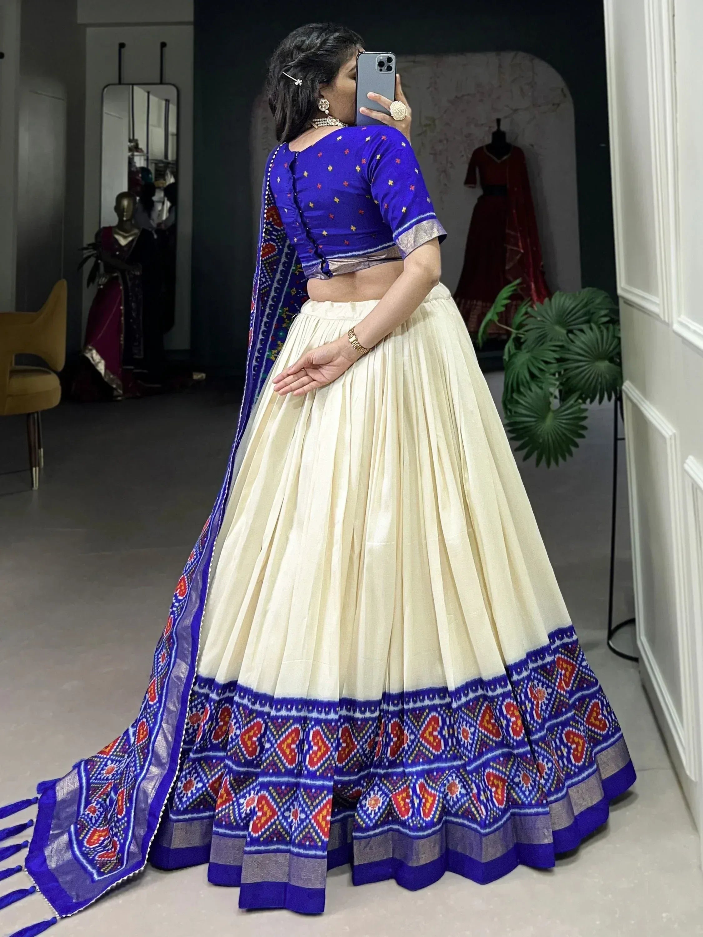 Woman in blue and cream lehenga choli with Ikat print, perfect for Indian ethnic wear occasions