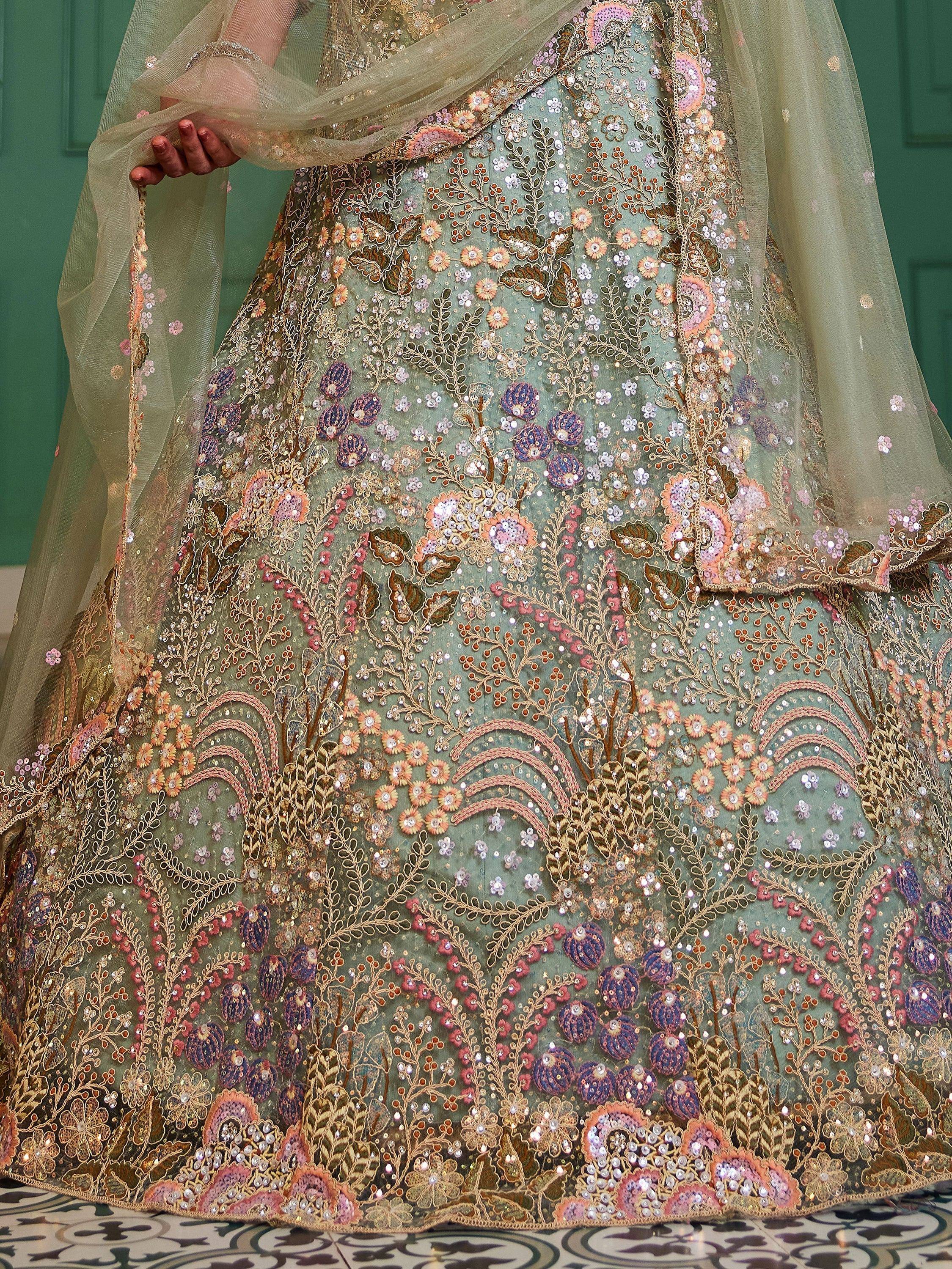 Elegant mint green lehenga choli with intricate floral embroidery and sequin detailing, perfect for Indian weddings.