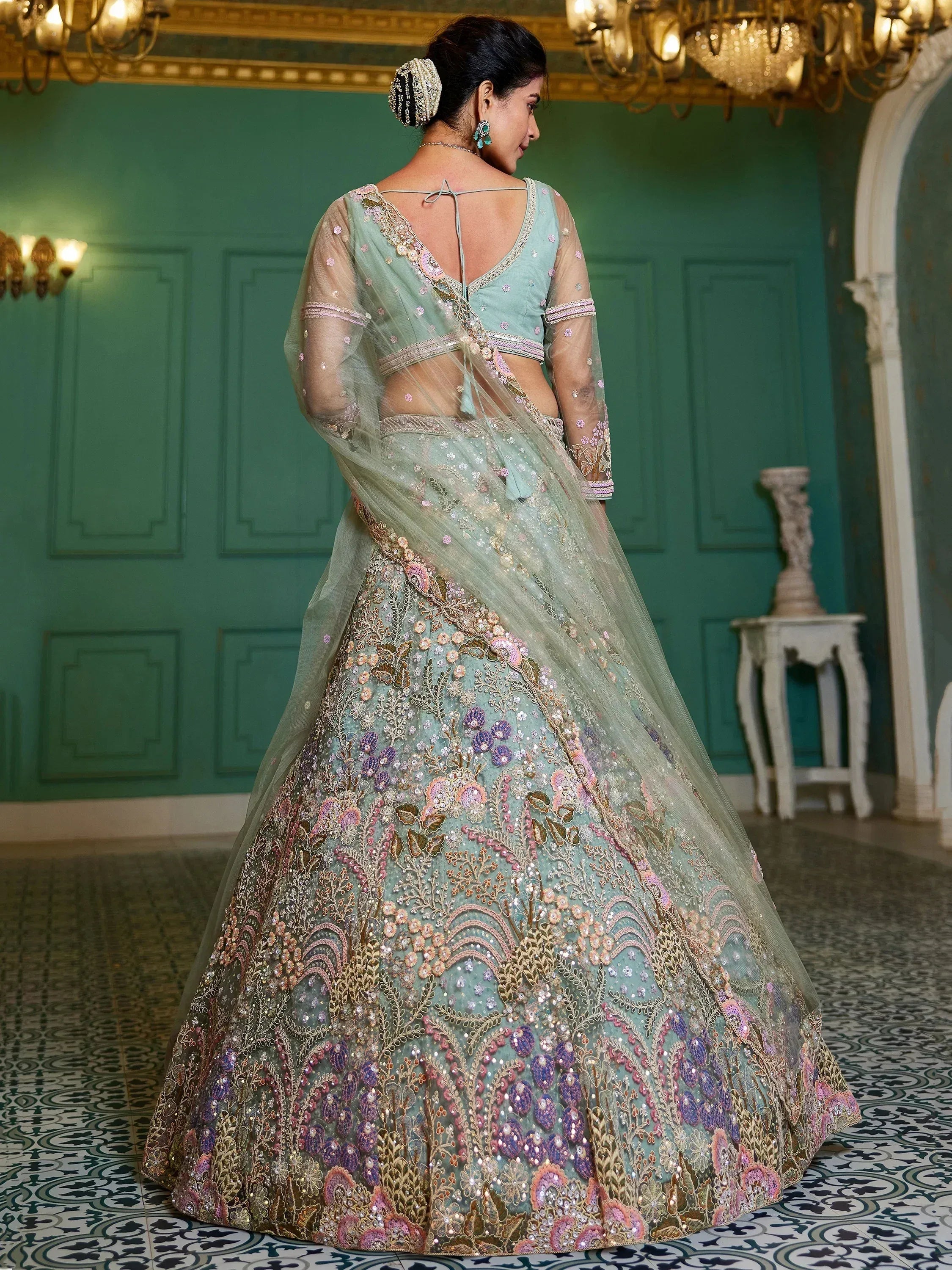 Mint green designer lehenga choli with floral embroidery, perfect for Indian weddings and festive occasions.