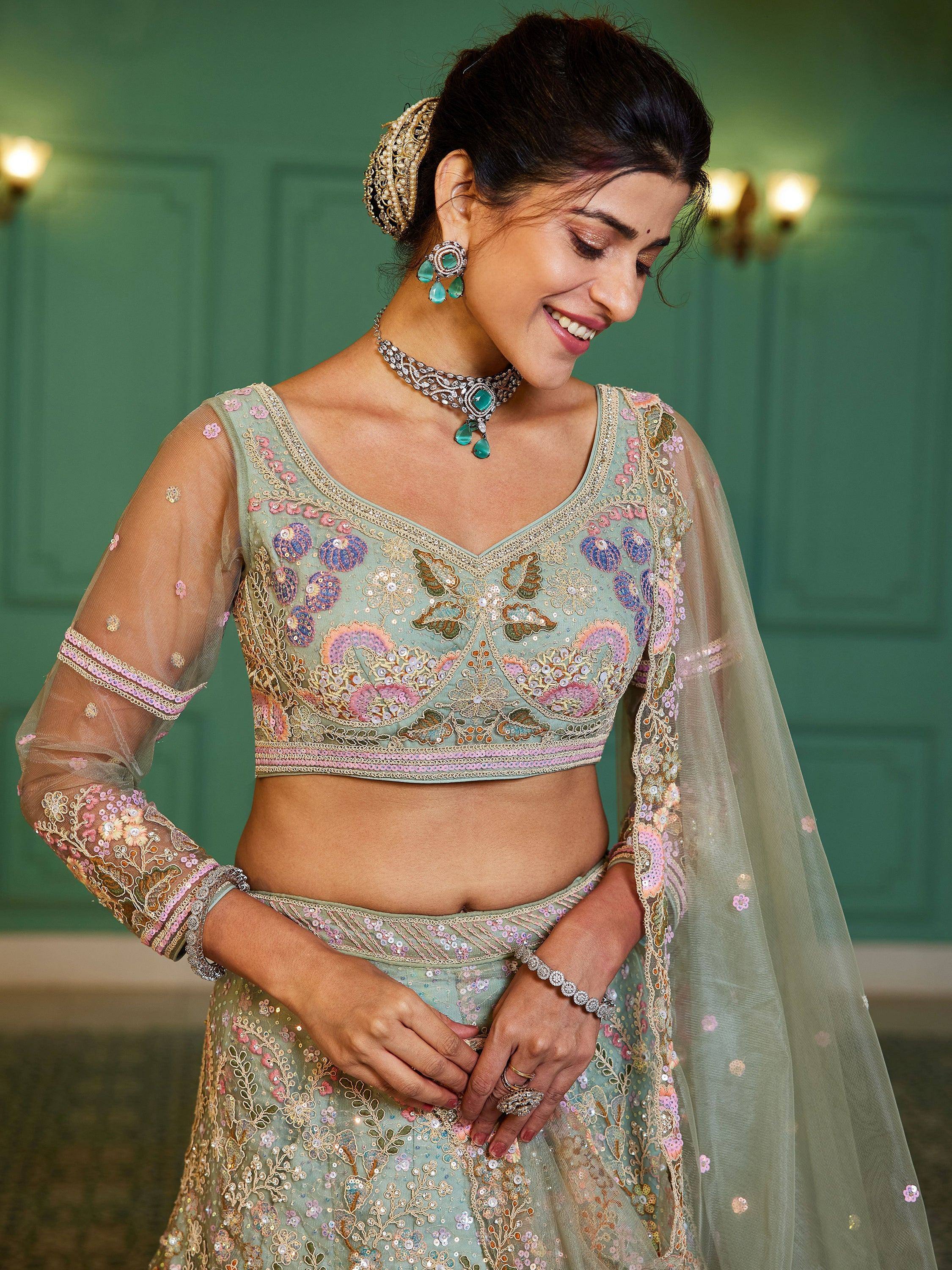 Elegant mint green lehenga choli with floral embroidery, perfect for Indian weddings and festive occasions.