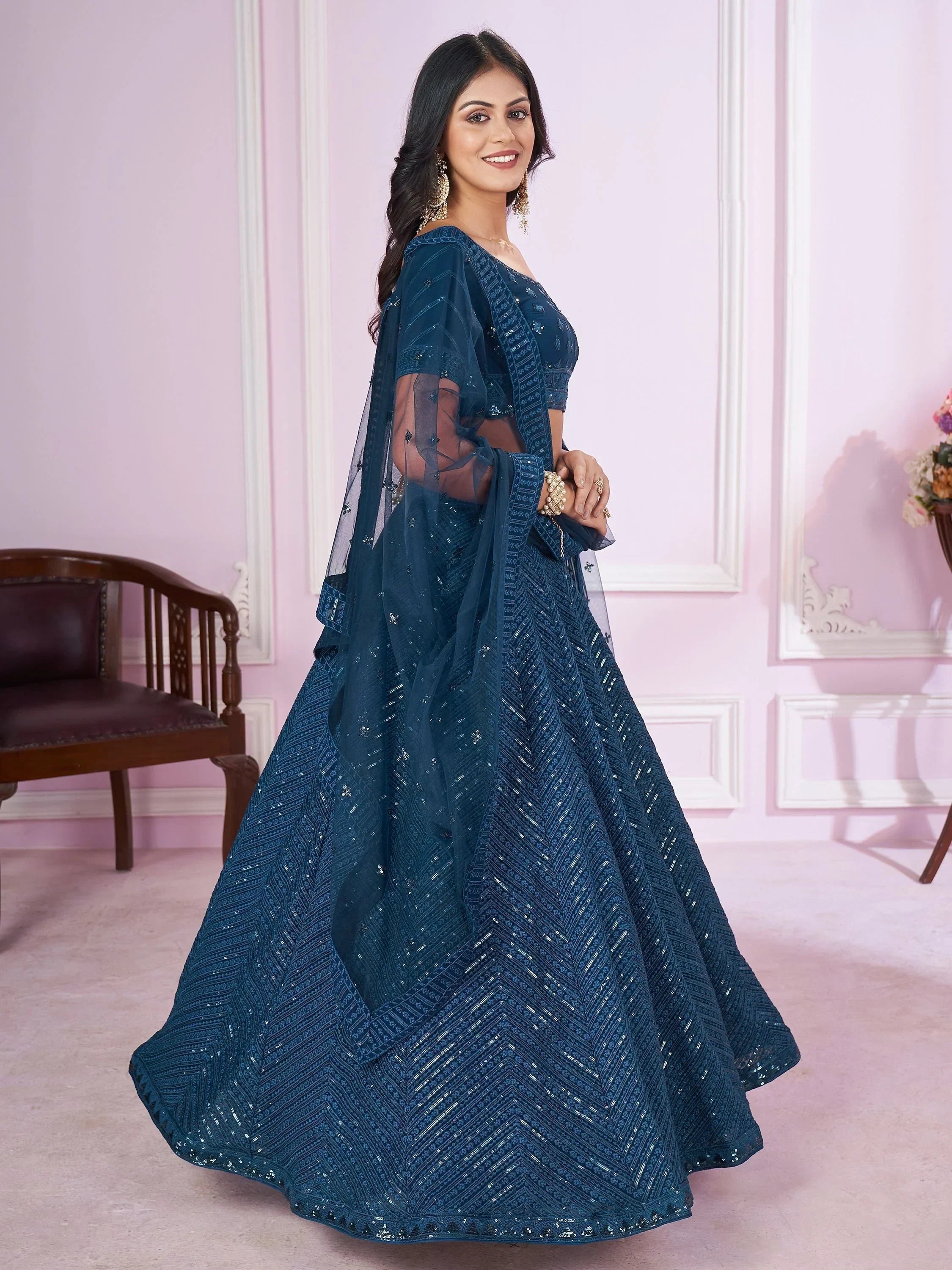 Elegant teal lehenga choli with intricate embroidery and sheer dupatta for Indian ethnic wear
