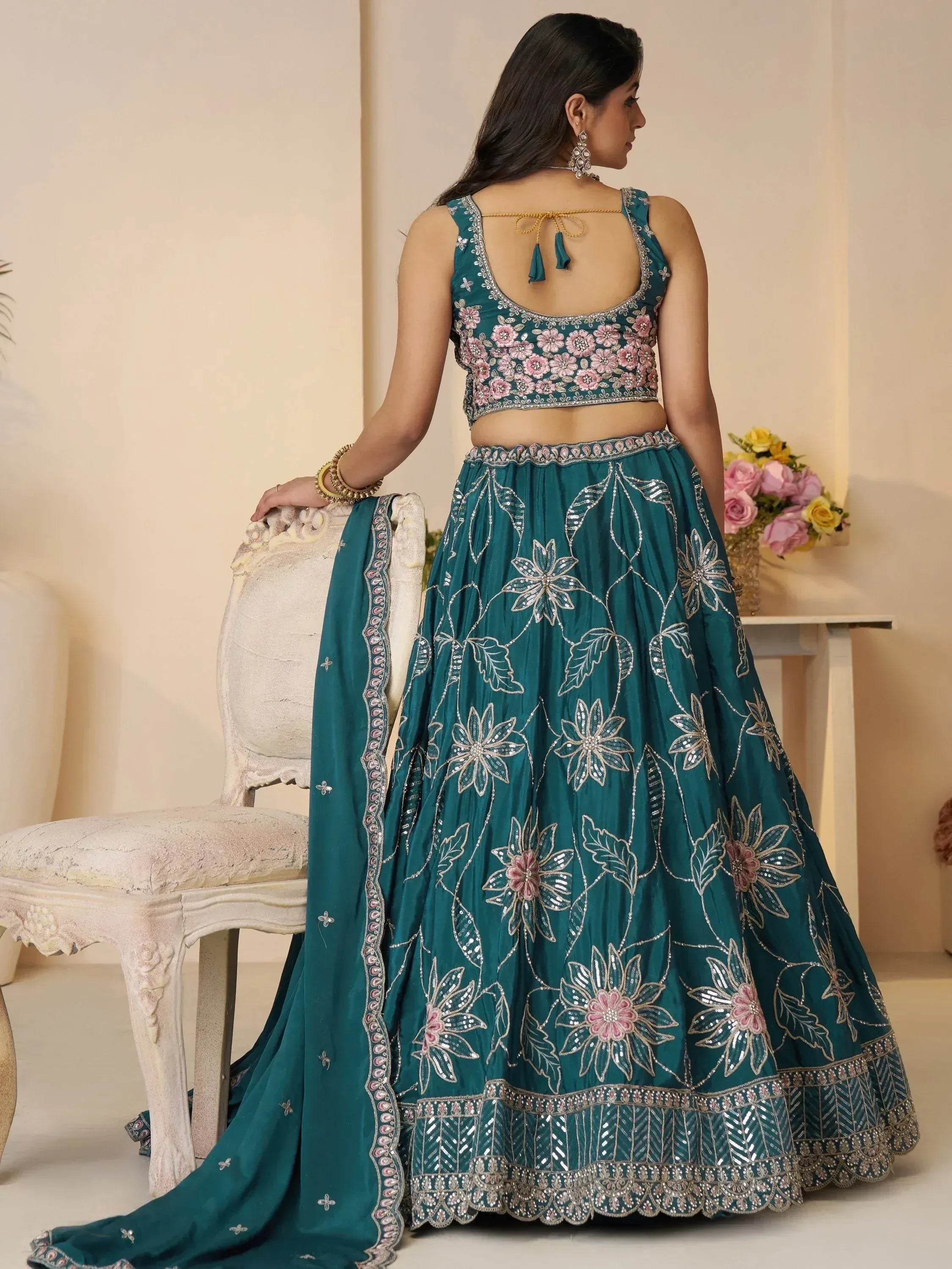 Teal floral embroidered lehenga choli with back tie blouse, perfect for Indian weddings and parties.