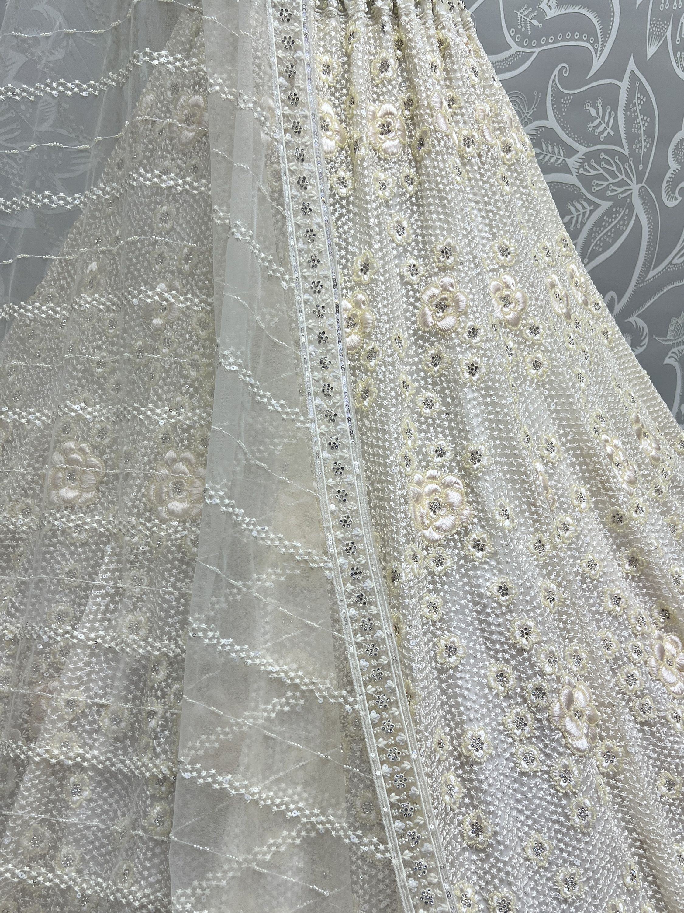 Elegant ivory lehenga with floral embroidery and sequin detailing, perfect for Indian ethnic wear.
