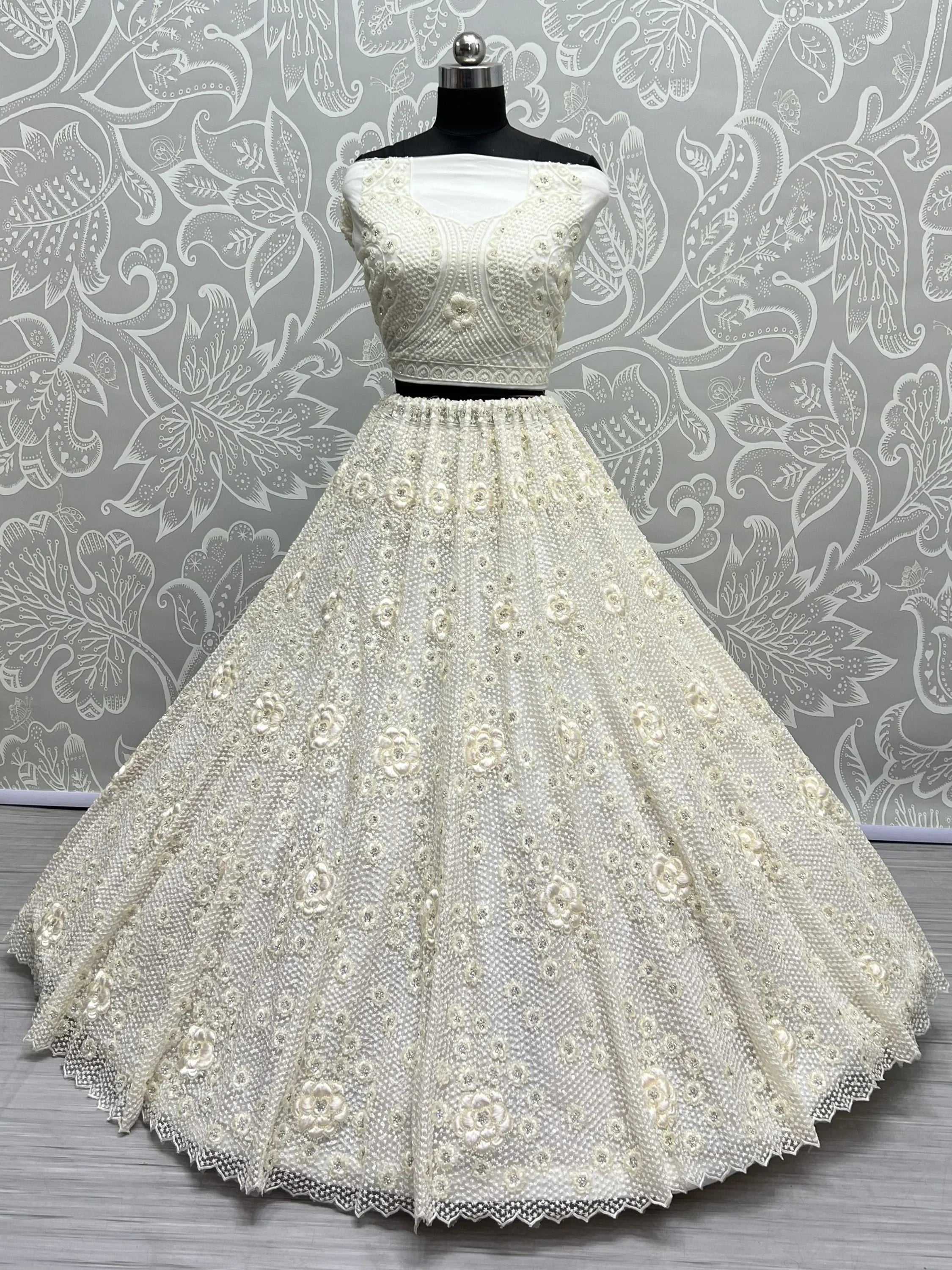 White embroidered lehenga choli with floral beadwork, perfect for Indian weddings and festive occasions.