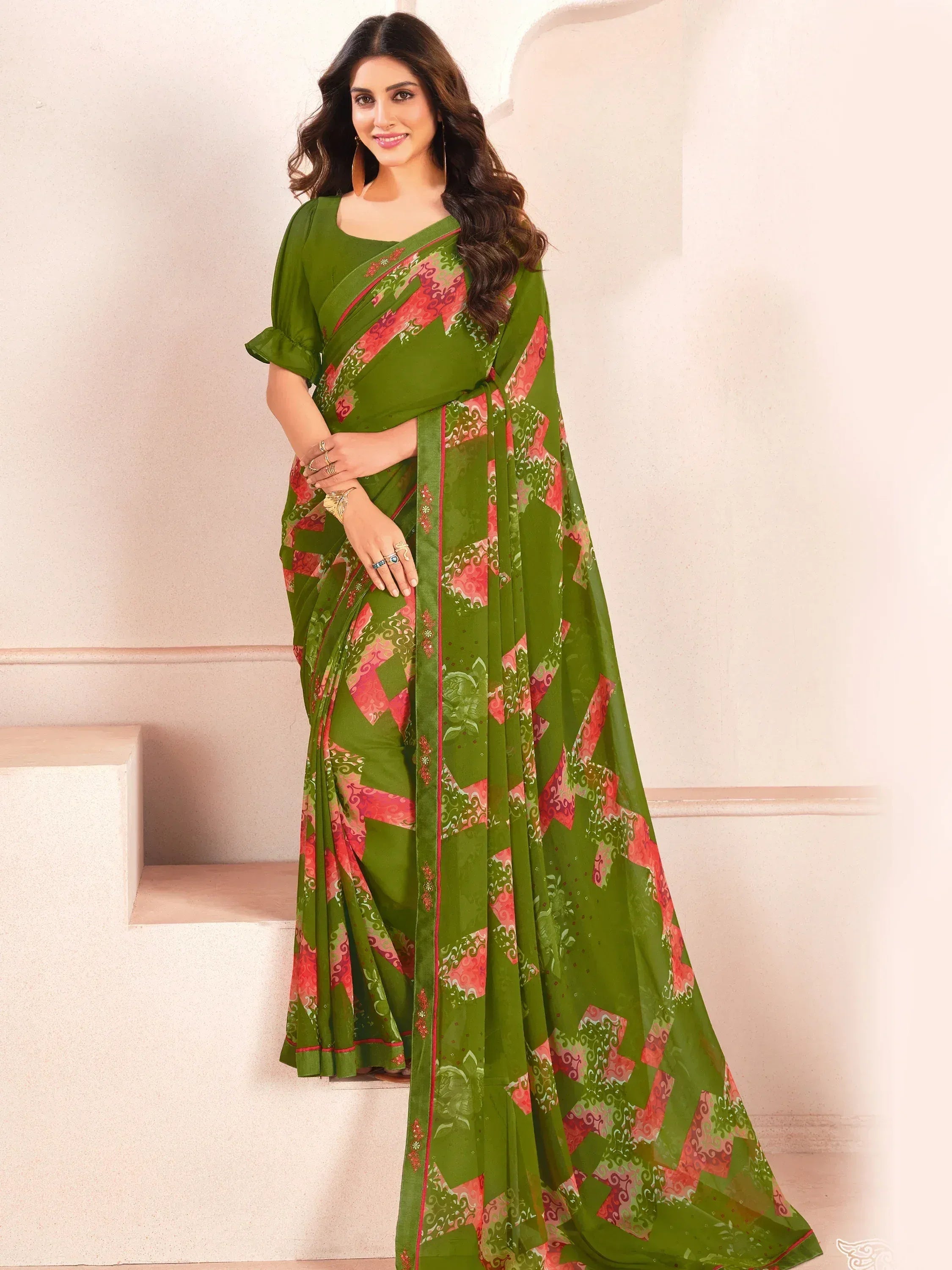 Green printed saree with pink geometric patterns, perfect for ethnic wear occasions