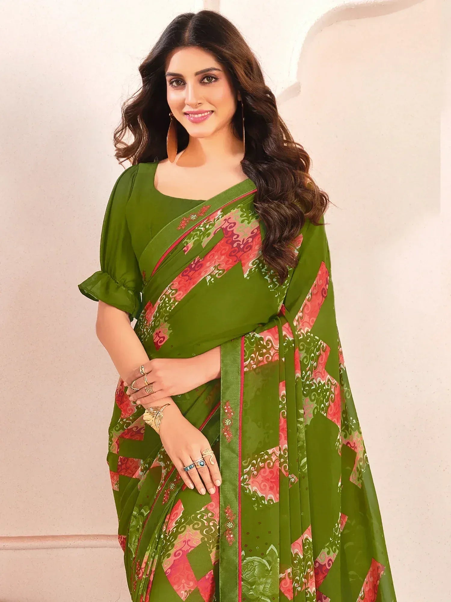 Green printed saree with pink floral border, paired with matching blouse, ideal for ethnic occasions