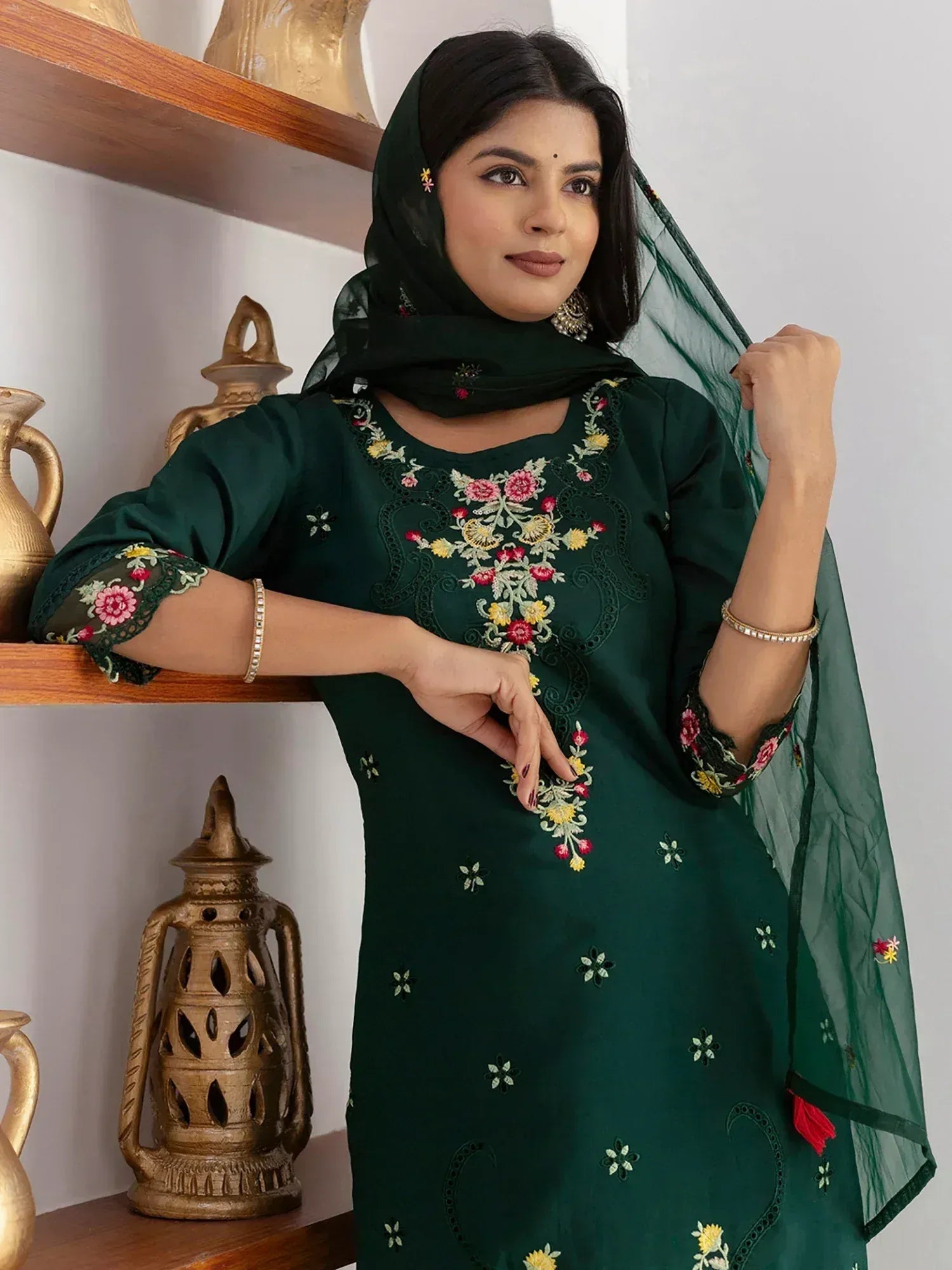 Emerald green embroidered salwar kameez with floral detailing and matching dupatta, perfect for ethnic occasions.