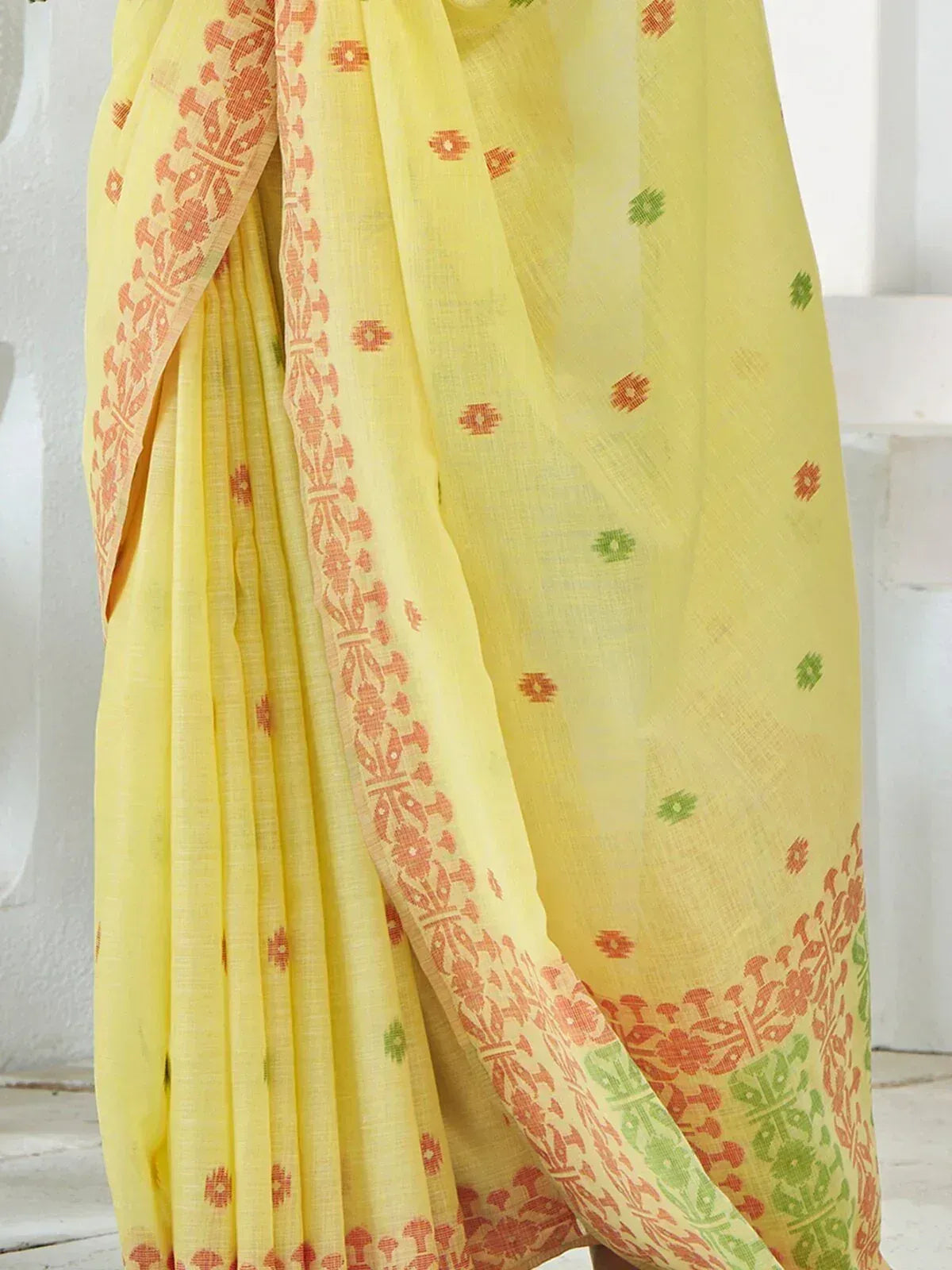 Yellow ethnic saree with orange and green block print patterns, perfect for Indian occasions