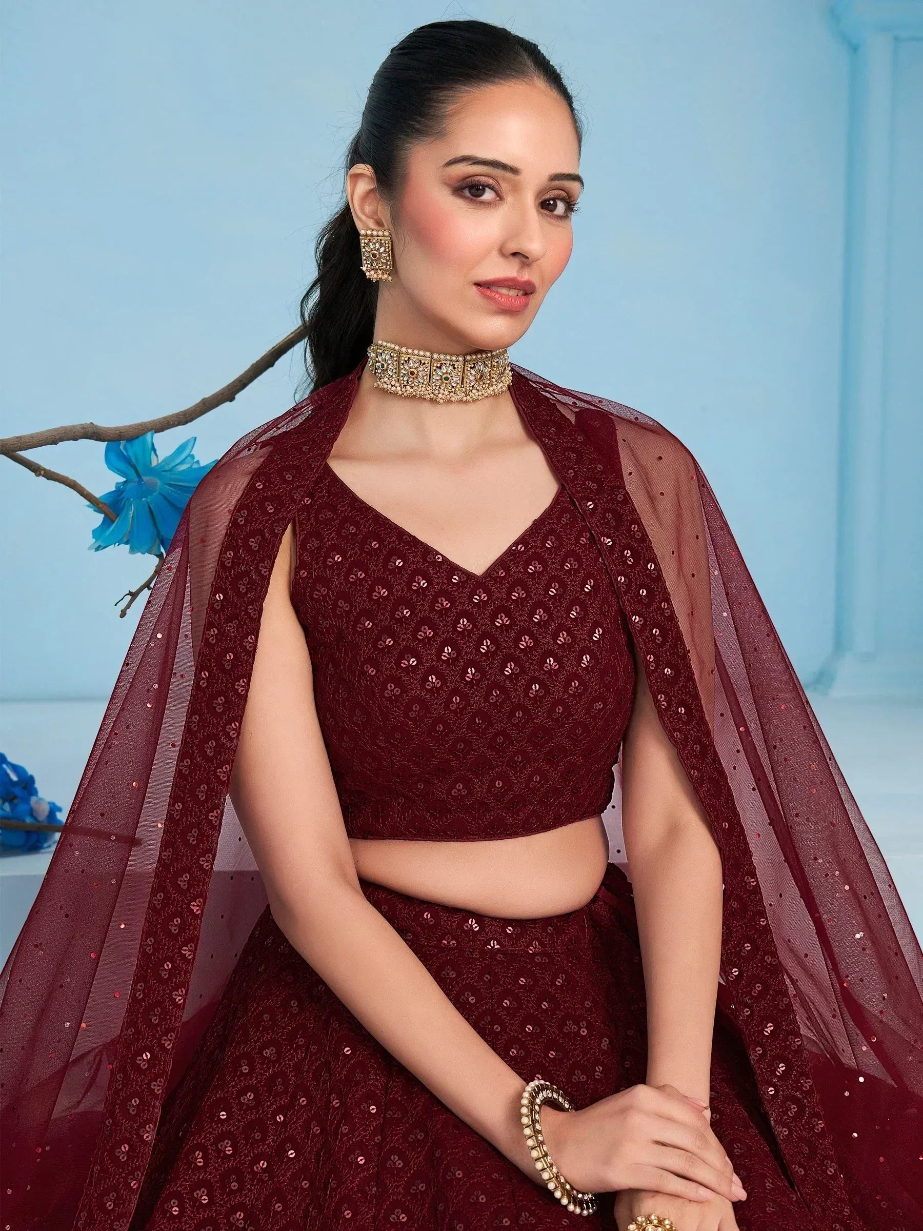 Maroon sequin lehenga choli with sheer cape, perfect for Indian ethnic wear and festive occasions.