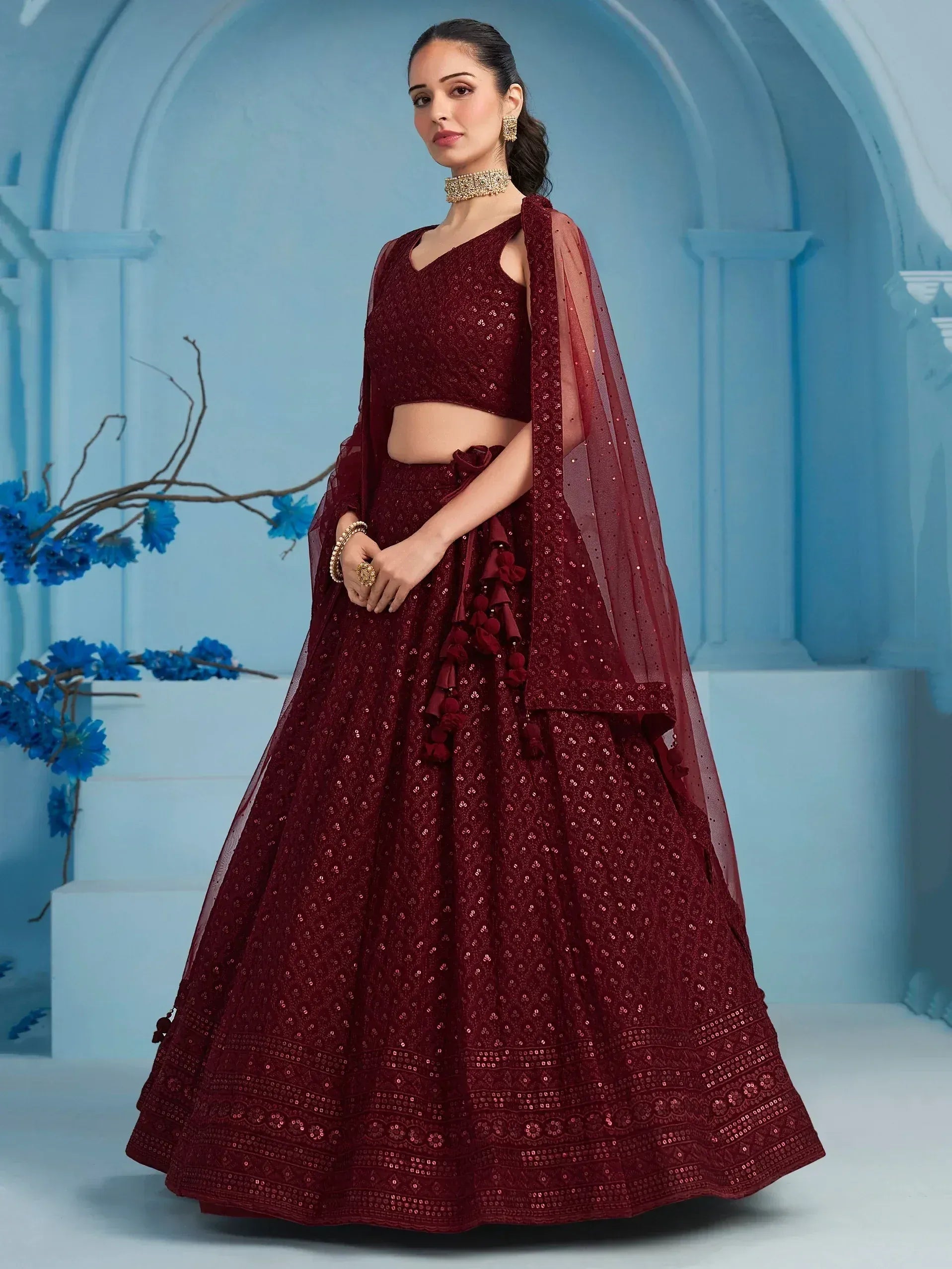 Burgundy sequin lehenga choli with tassels, perfect for Indian weddings and festive occasions.