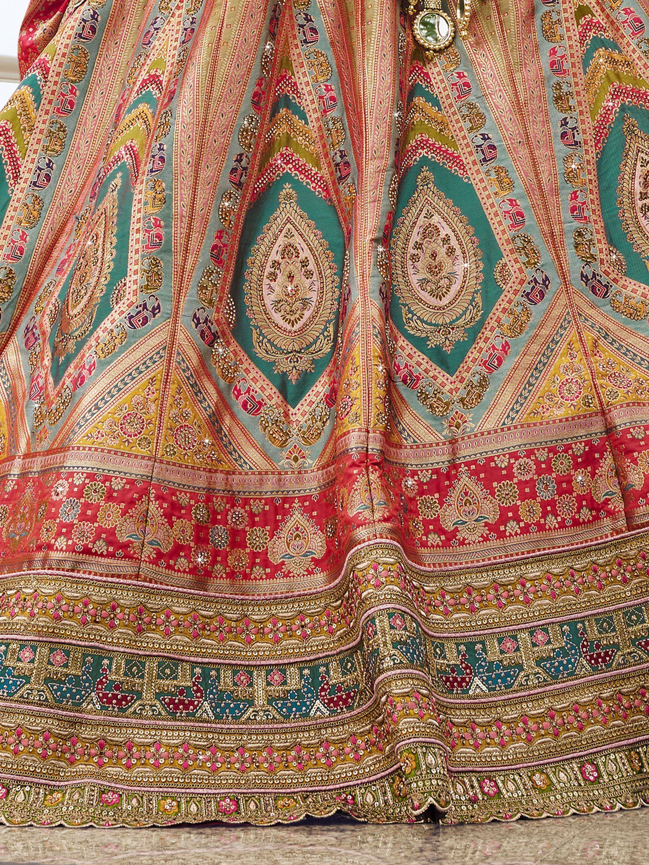 Designer lehenga choli with intricate paisley embroidery, vibrant colors, and detailed border work for Indian ethnic wear.