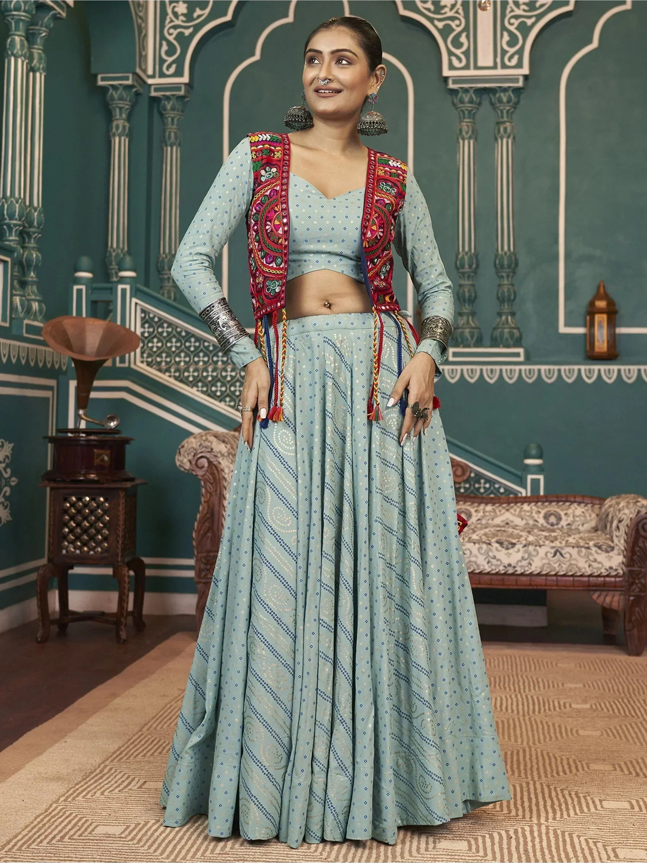 Woman in light blue embroidered lehenga choli with colorful dupatta, traditional Indian ethnic wear