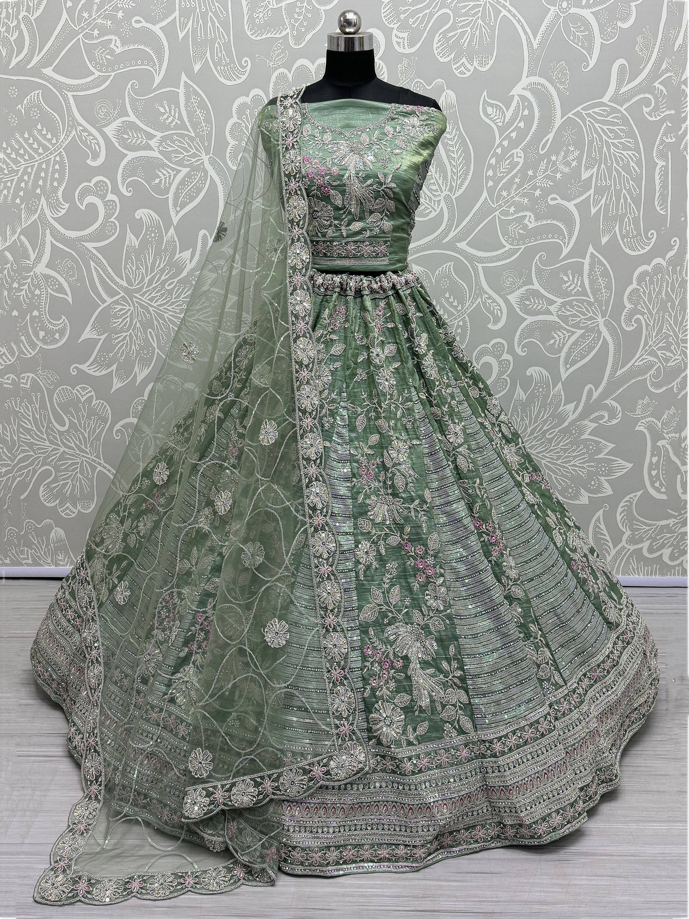 Green embroidered lehenga choli with floral motifs and sheer dupatta, perfect for Indian ethnic wear.