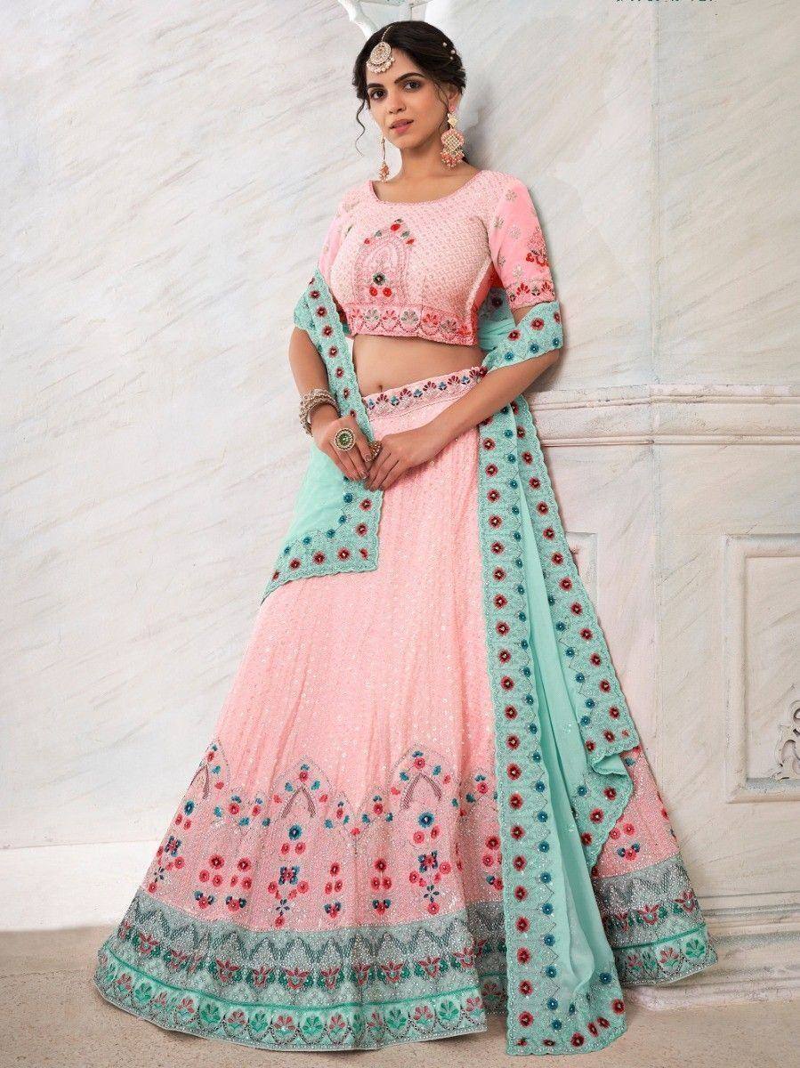Pink and mint green embroidered lehenga choli with floral detailing, perfect for Indian ethnic occasions.